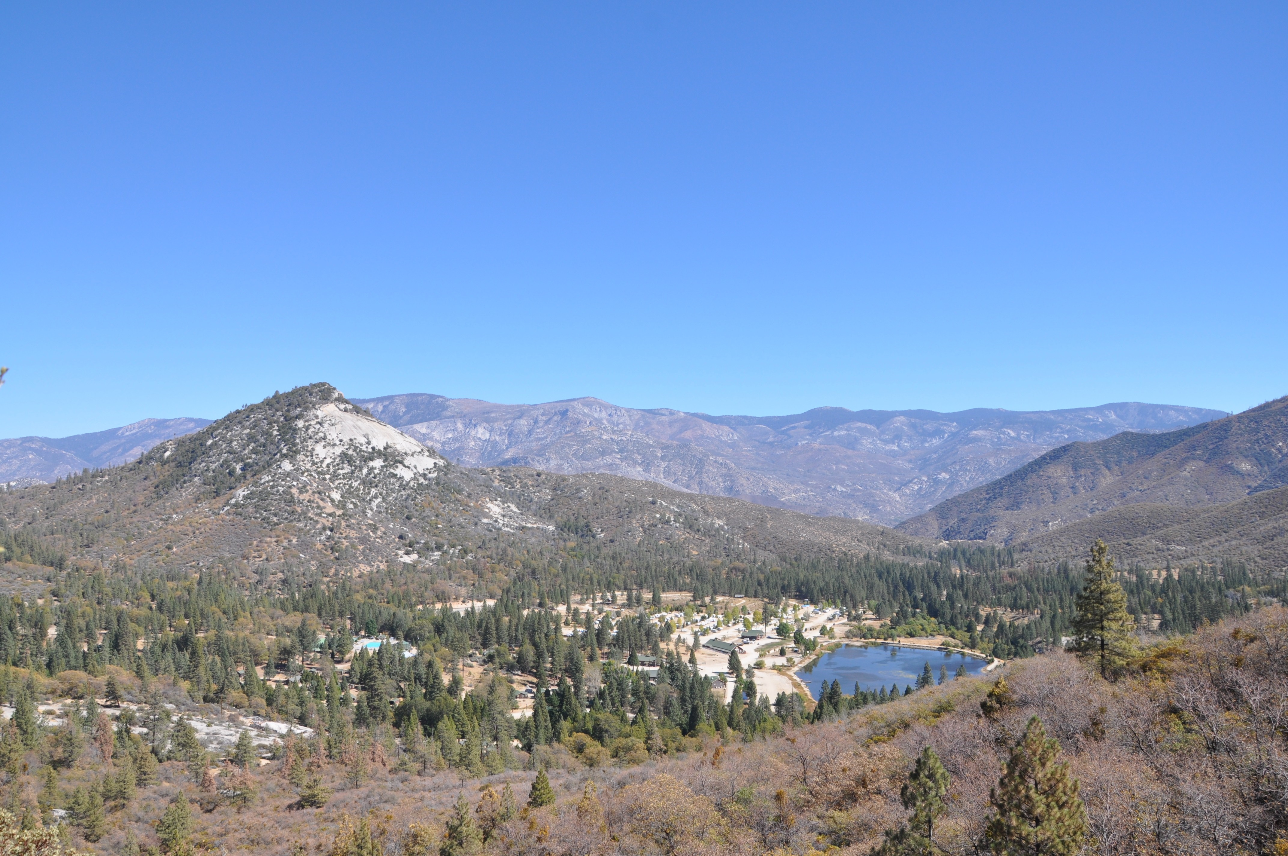 Mountain valley with a lake and forested hills HD Wallpaper