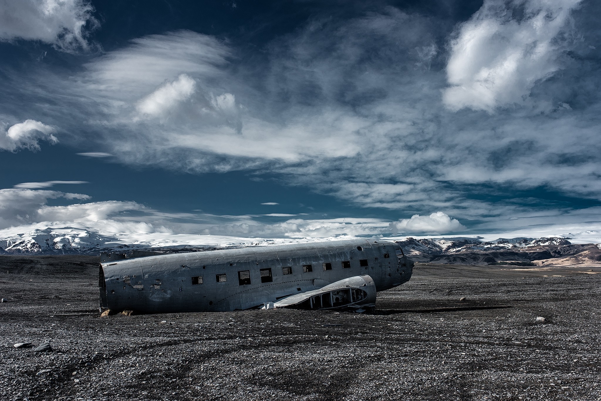 Abandoned airplane wreck on a rocky landscape in Iceland HD Wallpaper