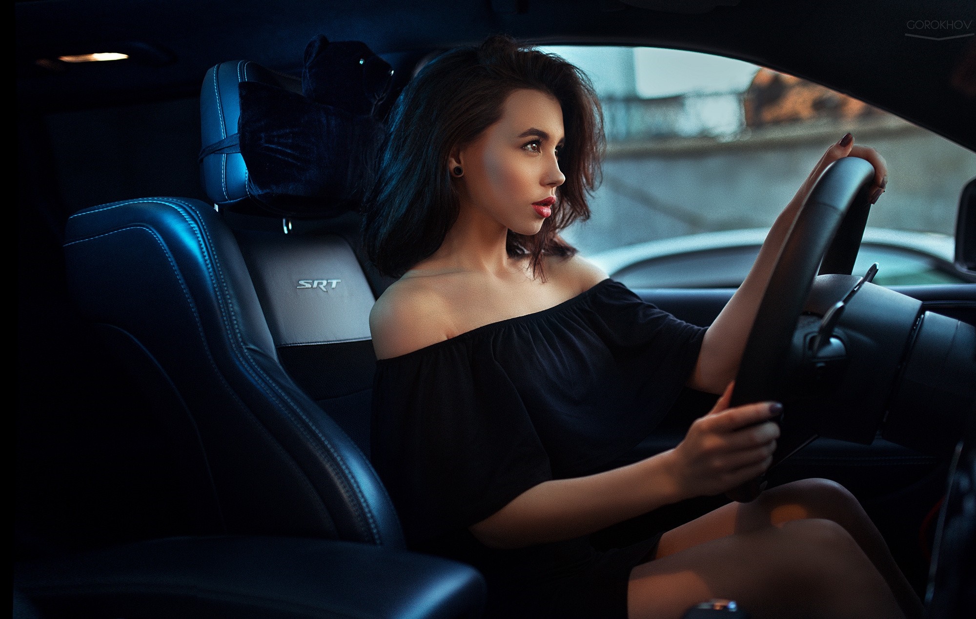Woman in black dress driving a car HD Wallpaper