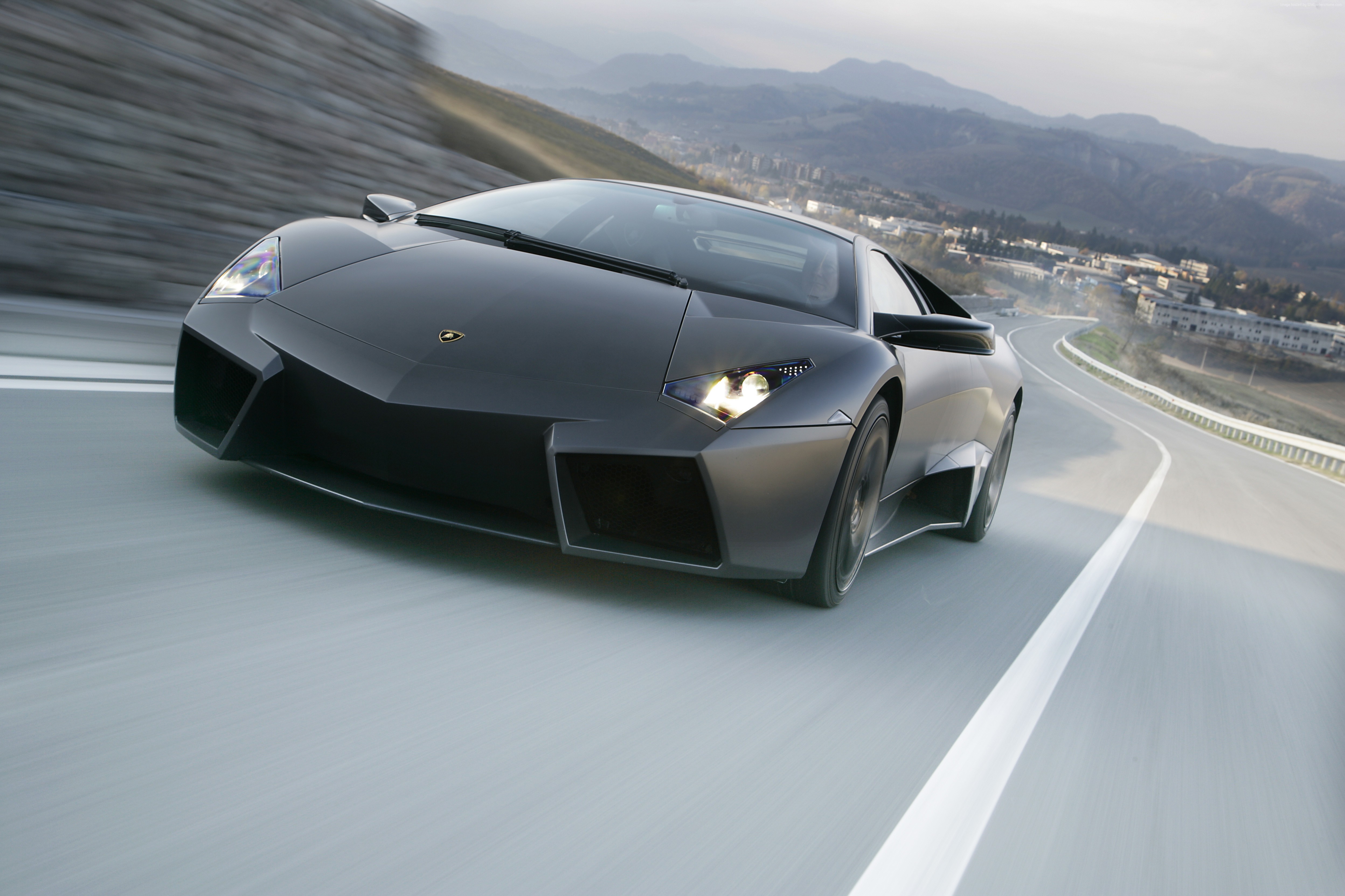Lamborghini Reventon driving on a winding road HD Wallpaper