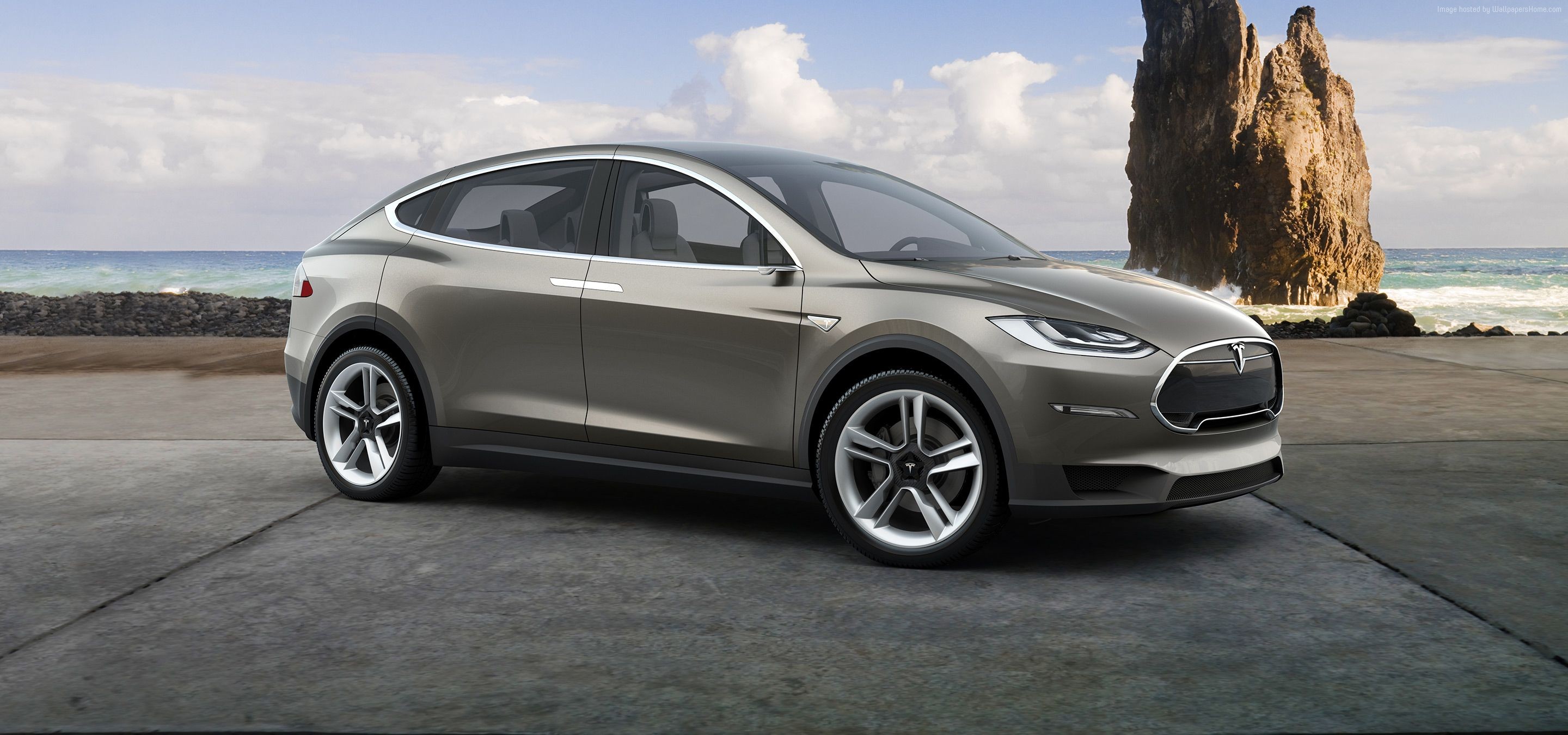 Tesla Model X electric SUV on a rocky coast HD Wallpaper