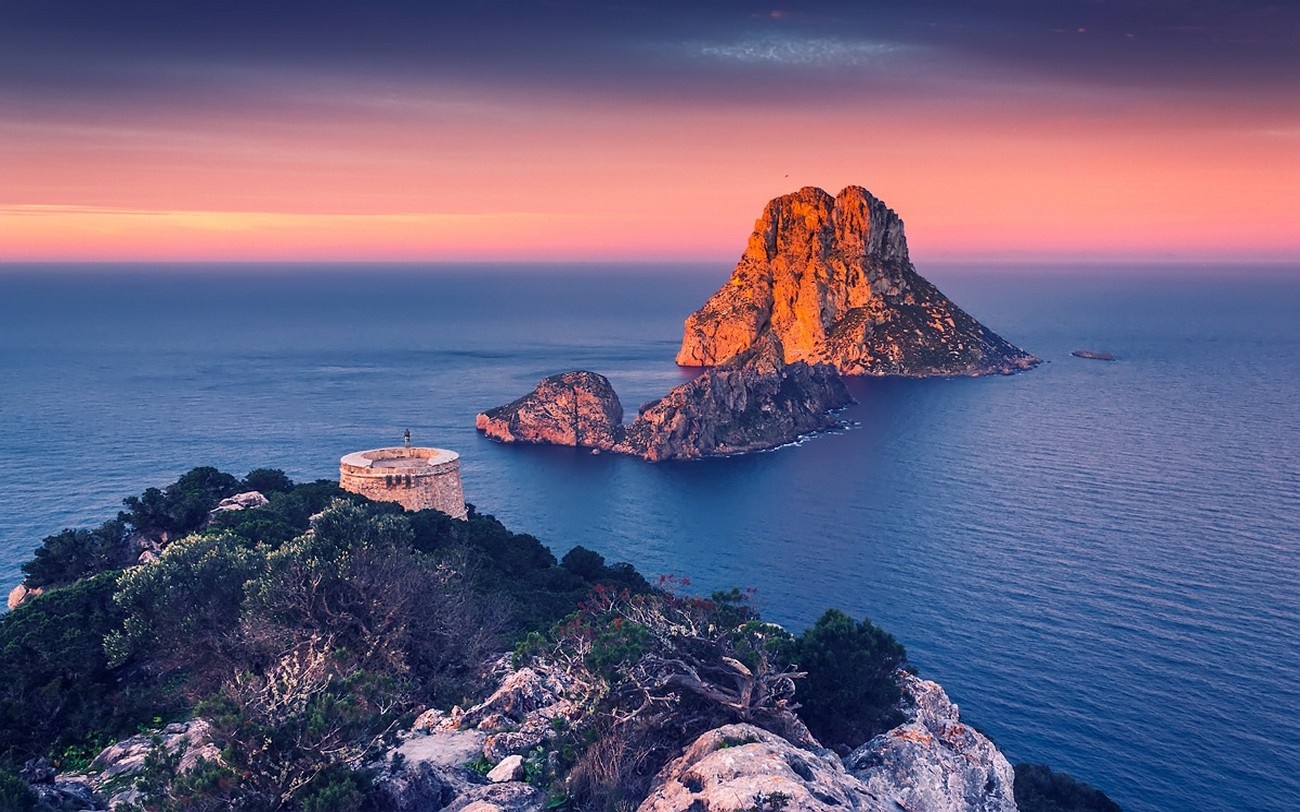 Es Vedrà island at sunset with tower on cliff HD Wallpaper
