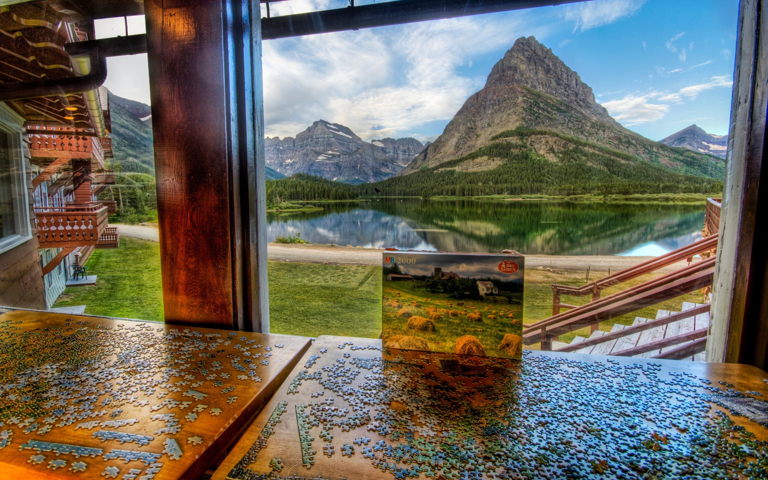 Puzzle box on table with mountain lake reflection HD Wallpaper