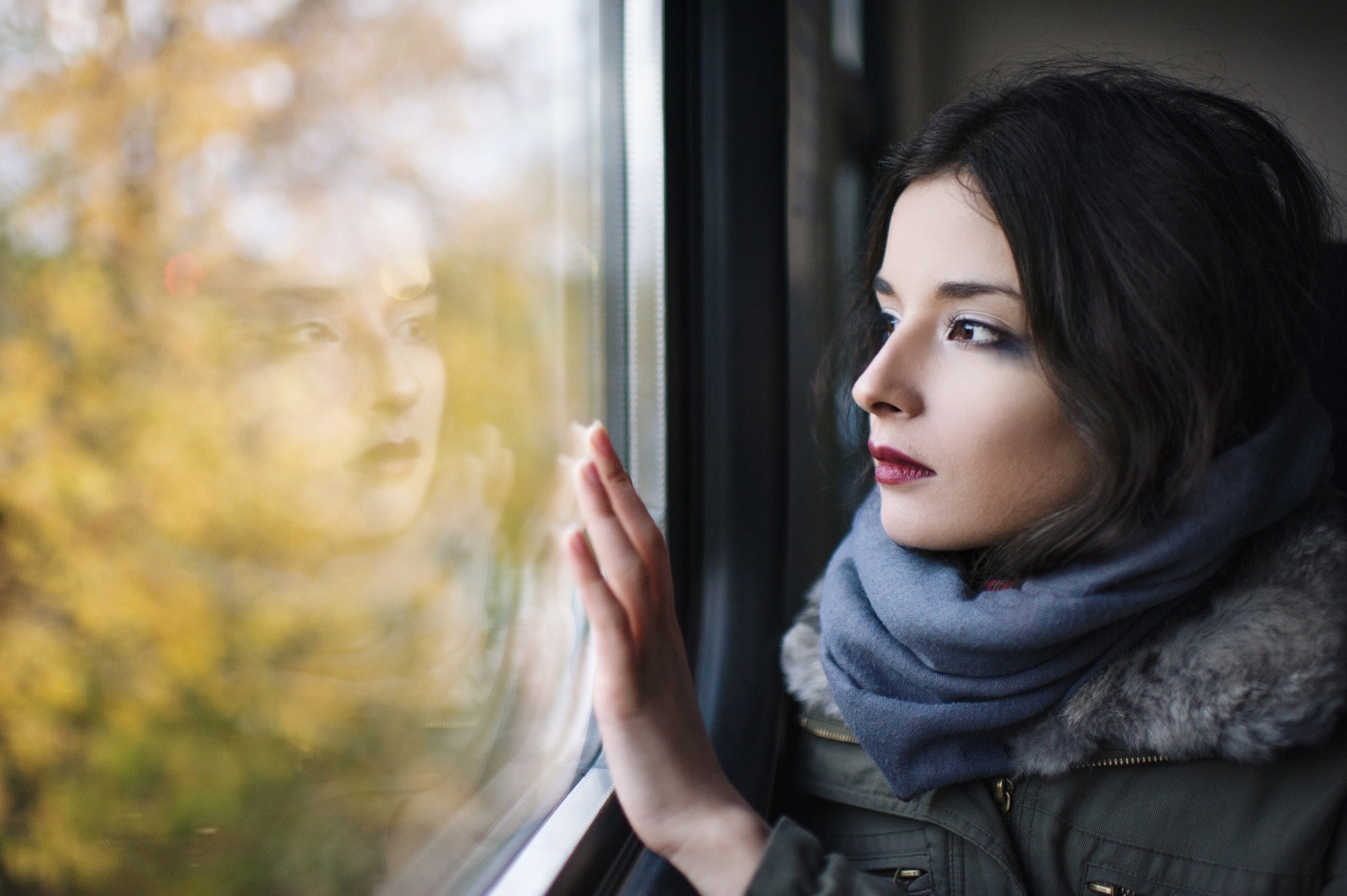 Woman looking out a window with reflection HD Wallpaper