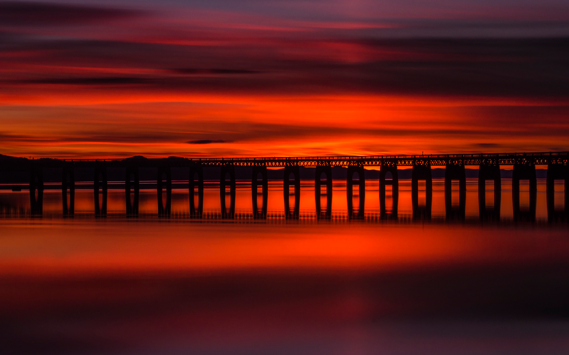 Long exposure sunset over a bridge and water HD Wallpaper