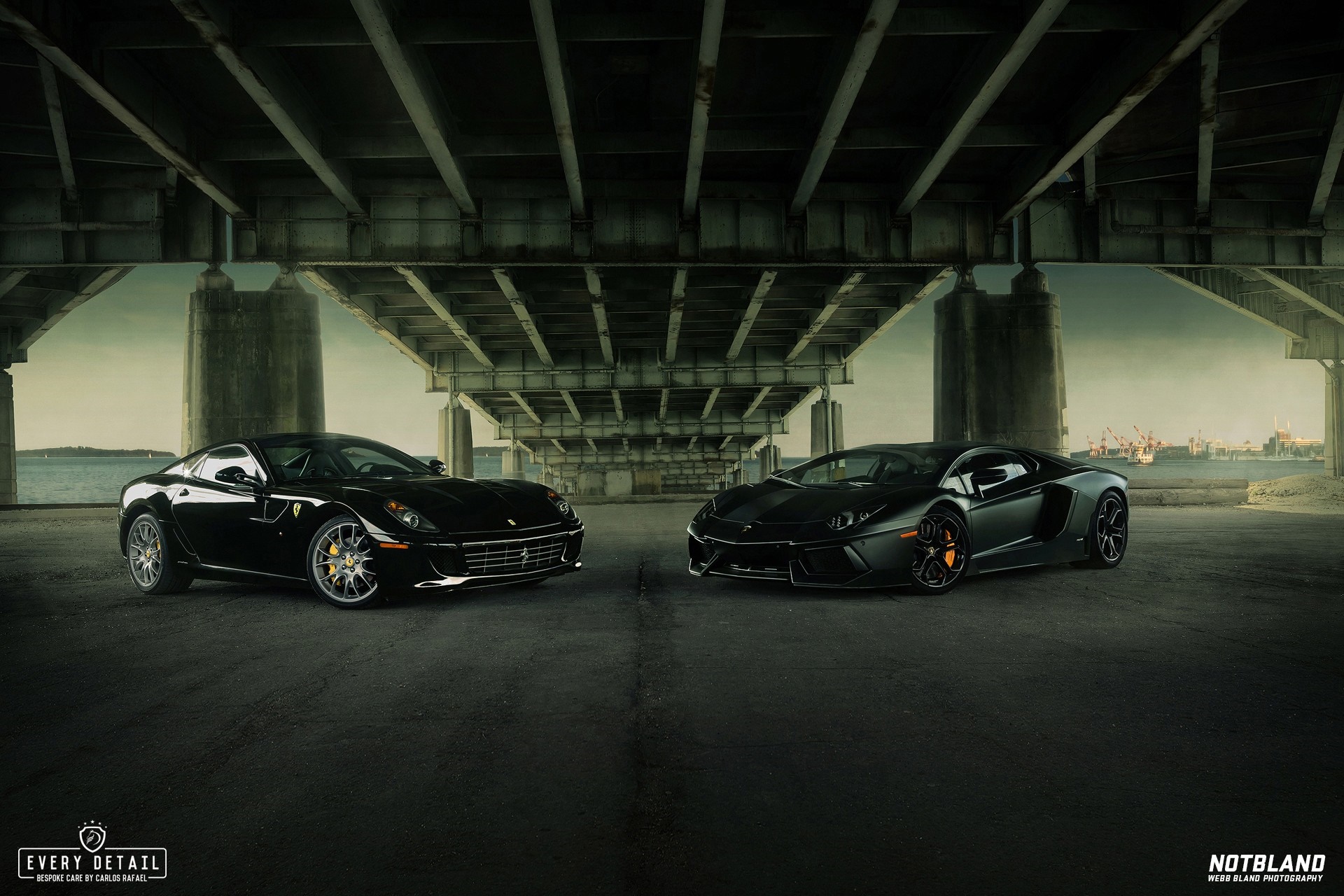 Black Ferrari and Lamborghini parked under a bridge HD Wallpaper