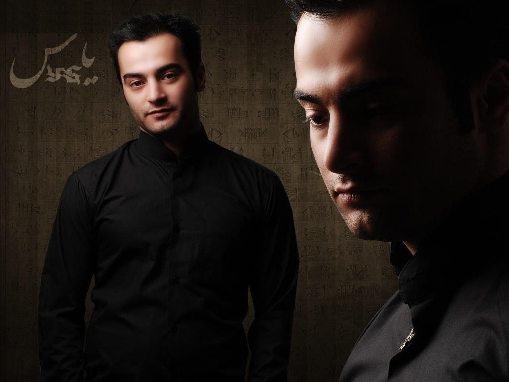 Man in Black Shirt with Arabic Text HD Wallpaper