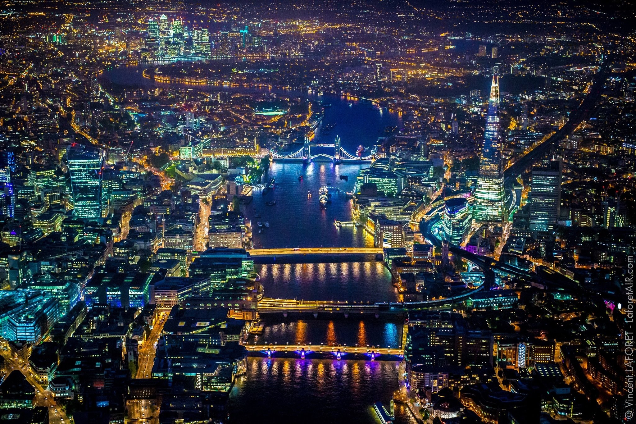 Aerial view of London cityscape at night with River Thames and Tower Bridge HD Wallpaper