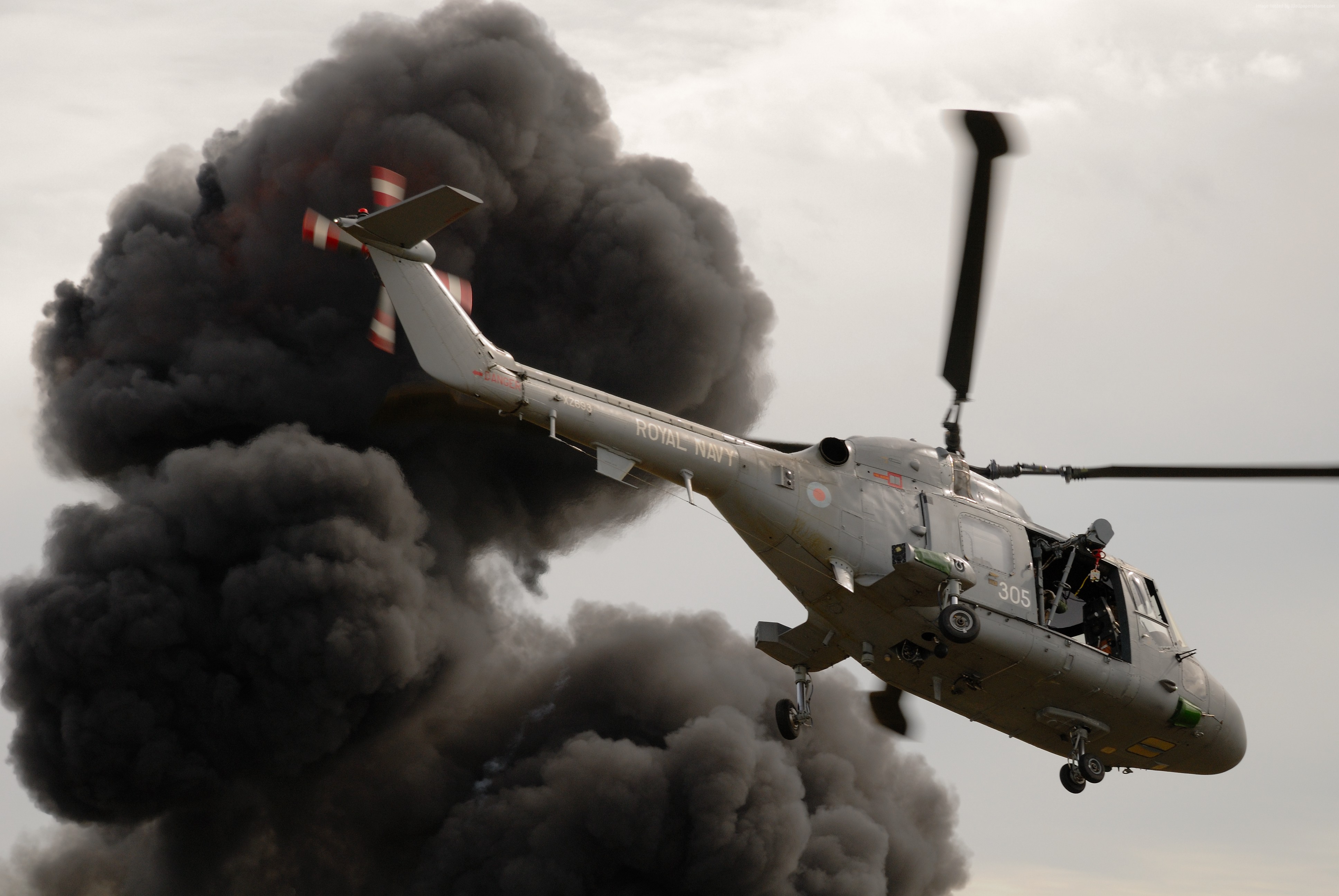Royal Navy Westland Lynx helicopter flying near black smoke HD Wallpaper