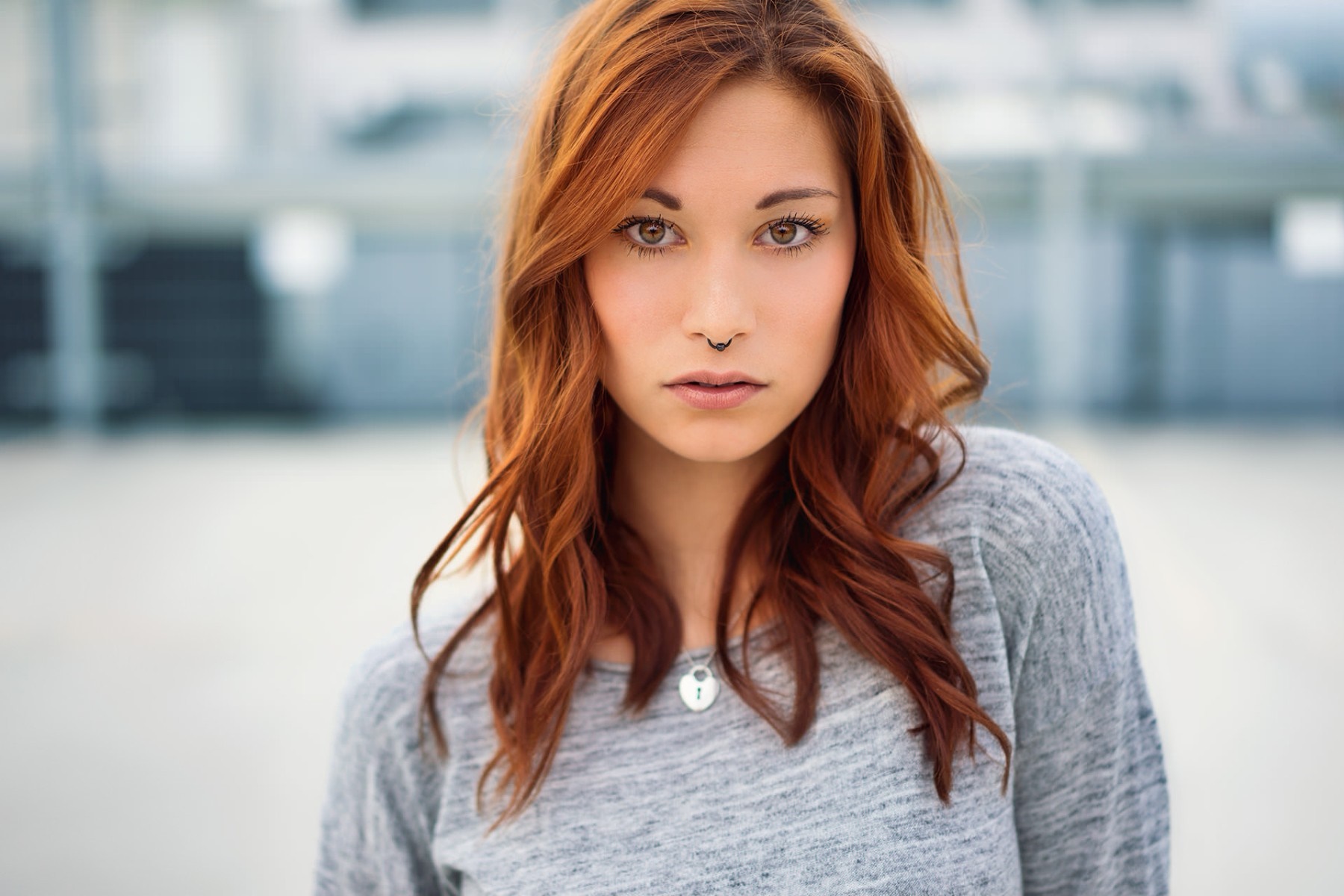 Woman with red hair and nose ring wearing a grey sweater HD Wallpaper