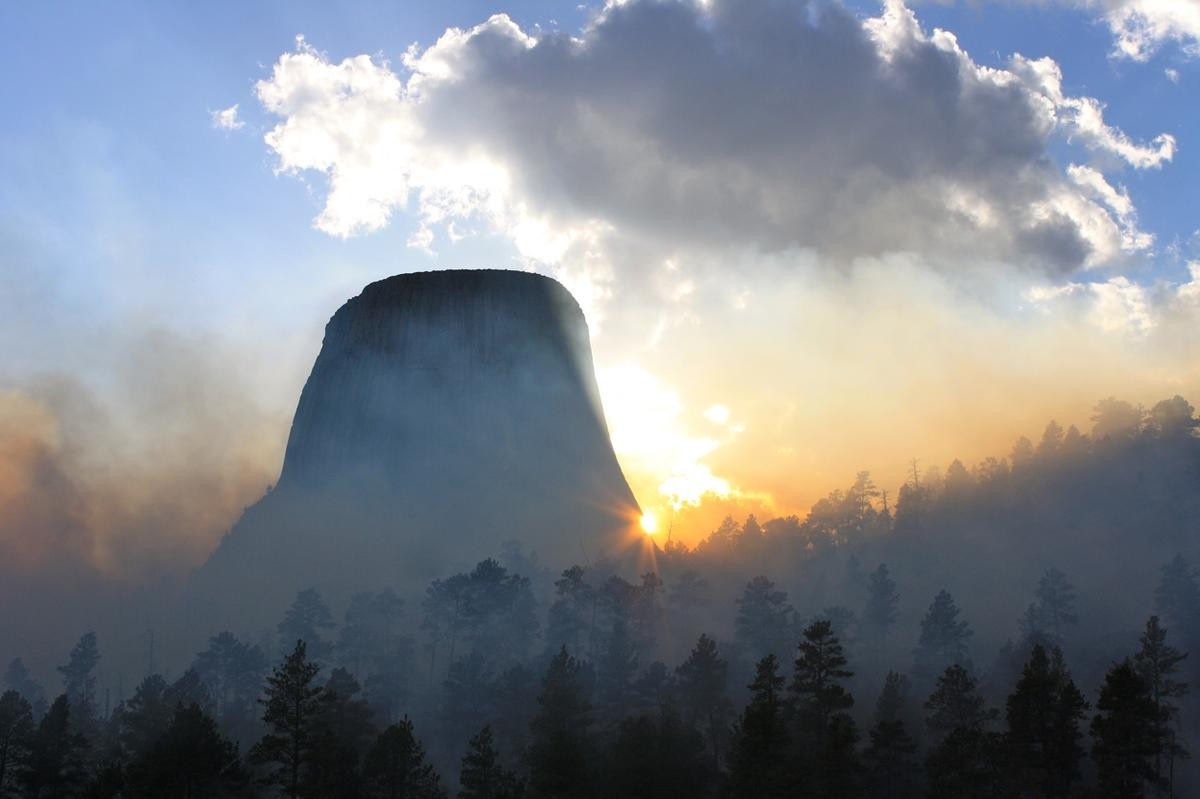 Devils Tower National Monument at sunrise with smoke HD Wallpaper