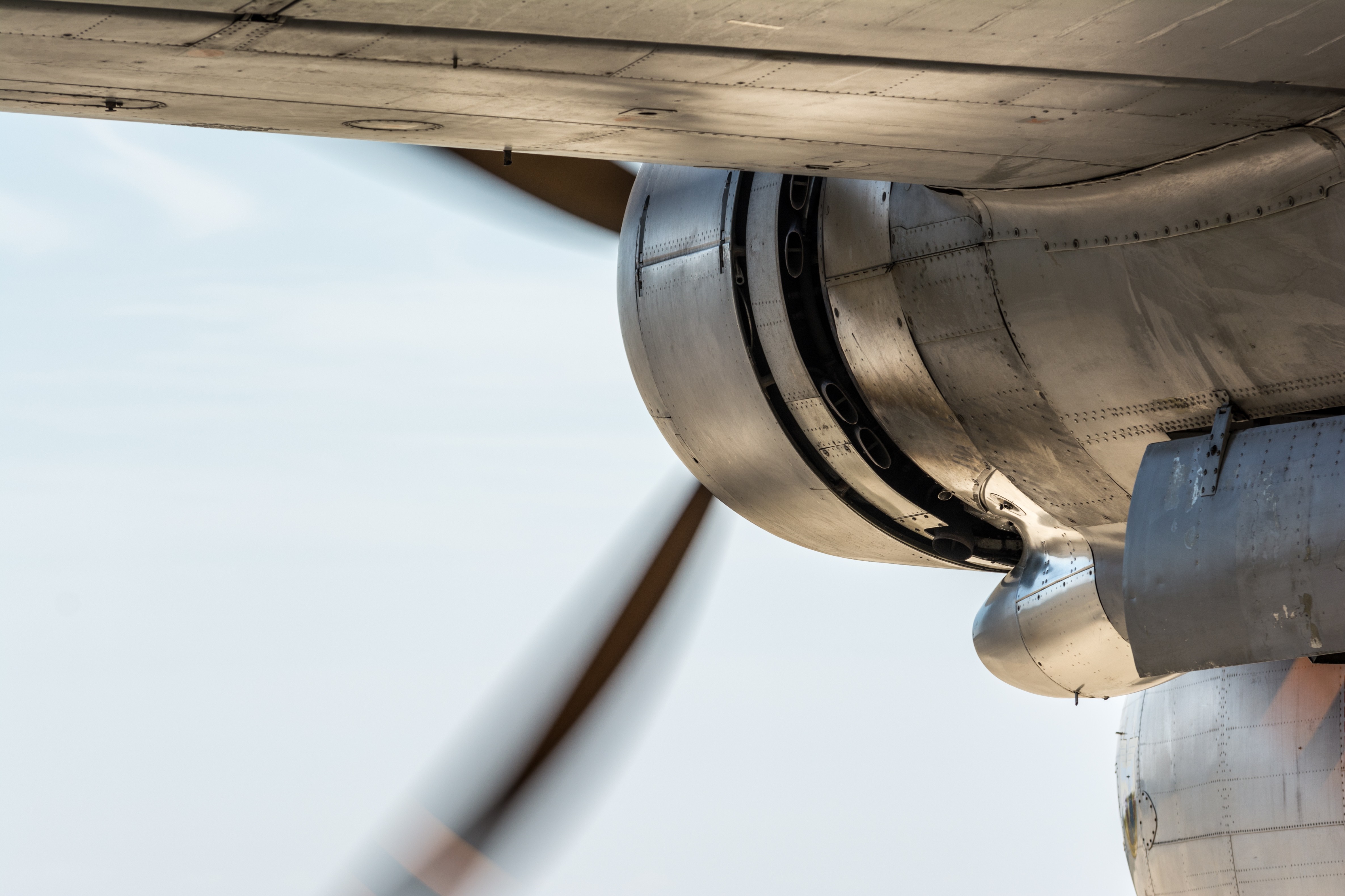 Close-up of an airplane engine and wing HD Wallpaper