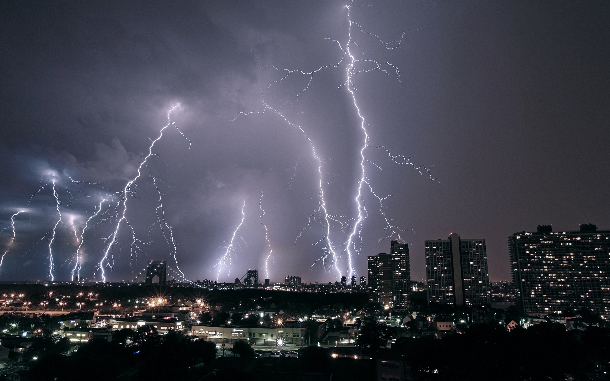 City skyline during a lightning storm at night HD Wallpaper