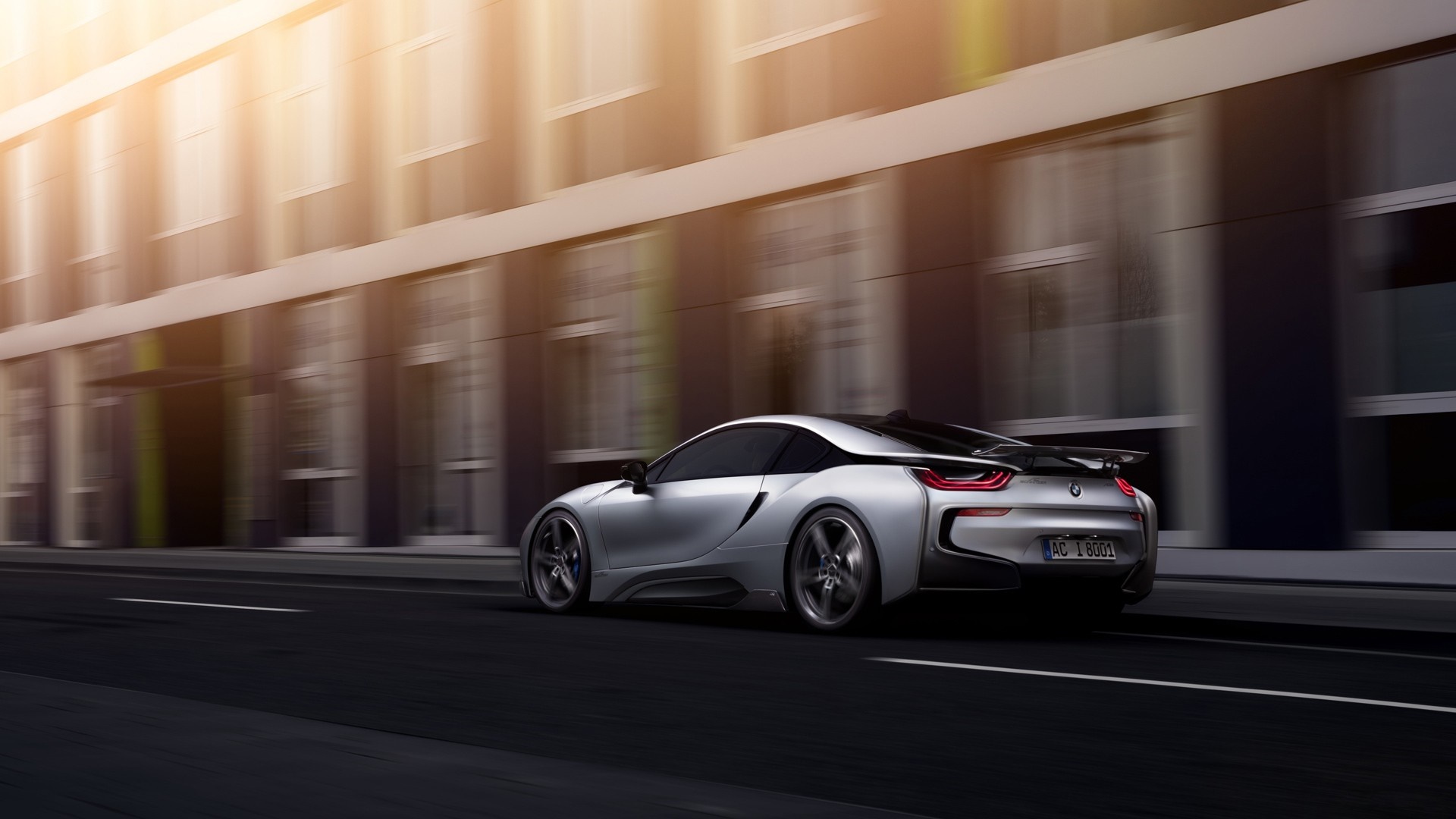 Silver BMW i8 driving on a city street HD Wallpaper