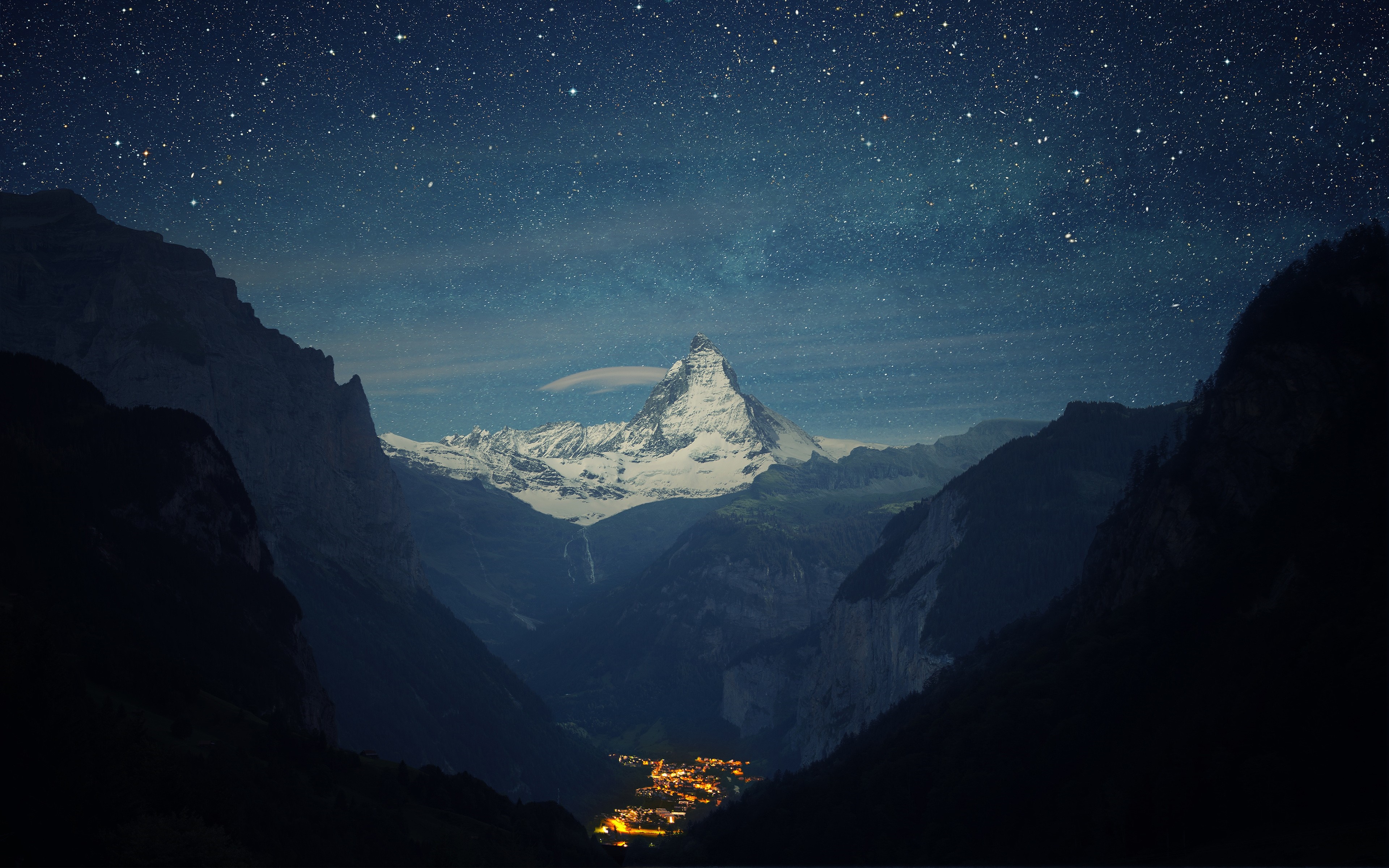 Matterhorn mountain at night with stars and a village HD Wallpaper
