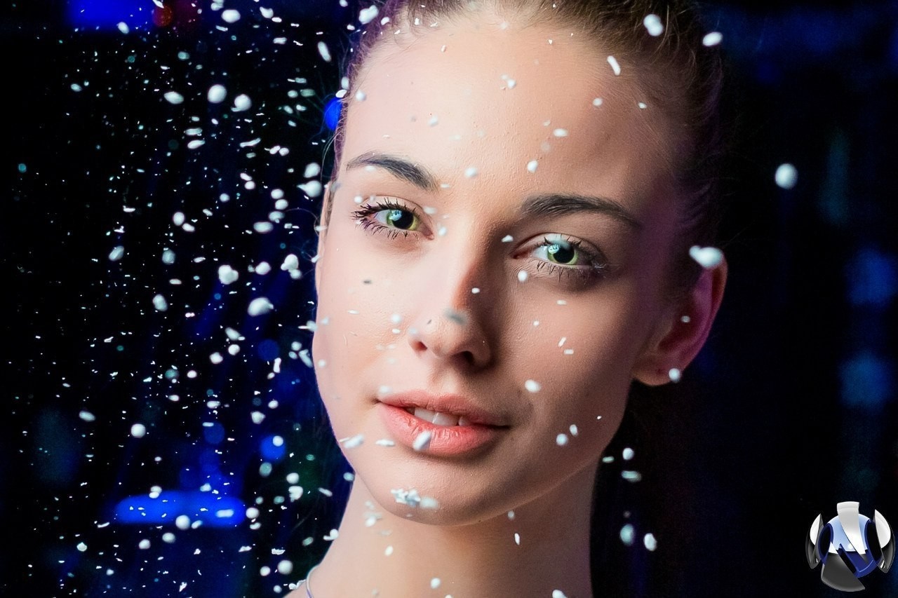 Woman with white particles on face, blue background HD Wallpaper