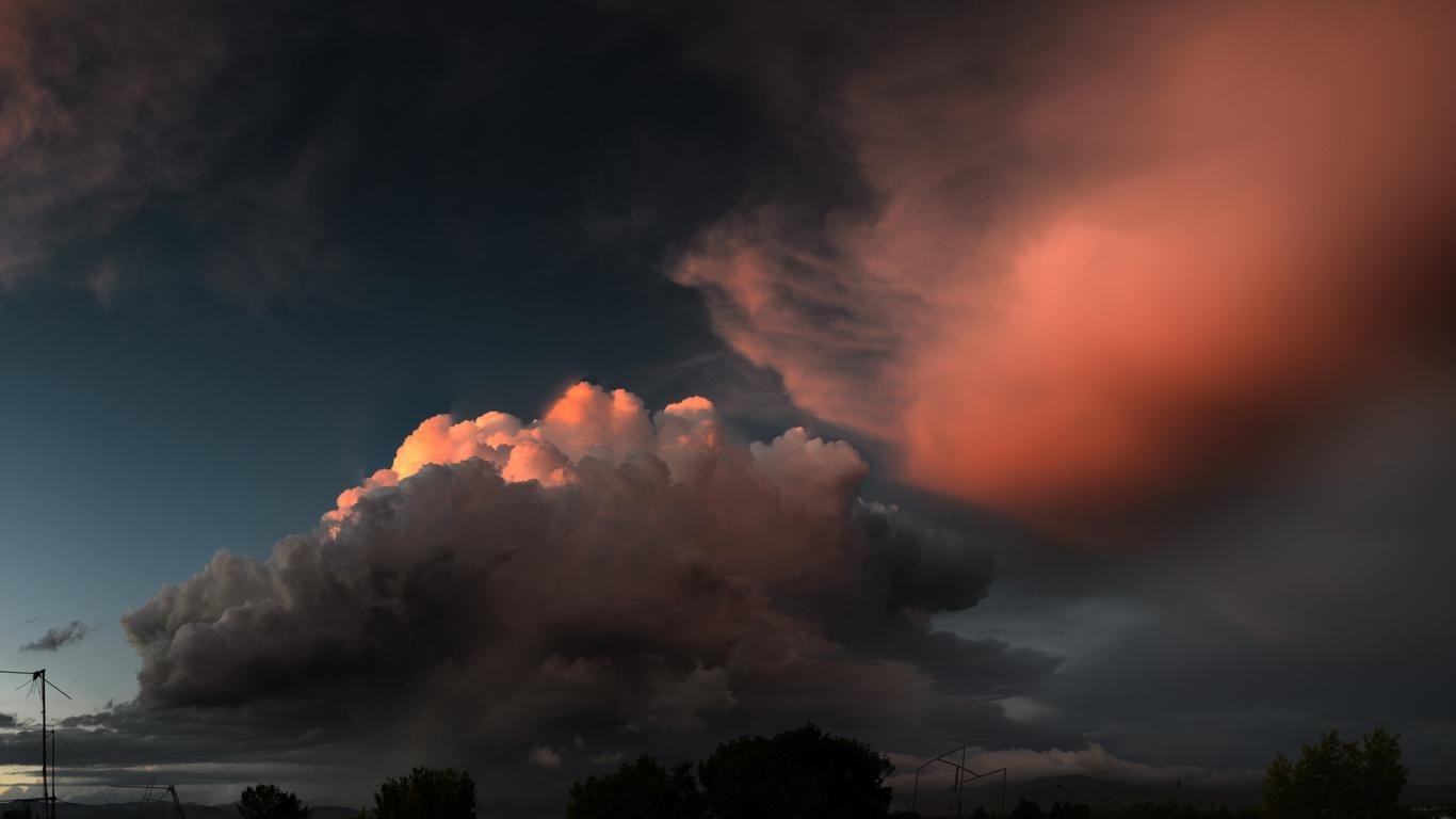 Dramatic sunset clouds over a landscape HD Wallpaper