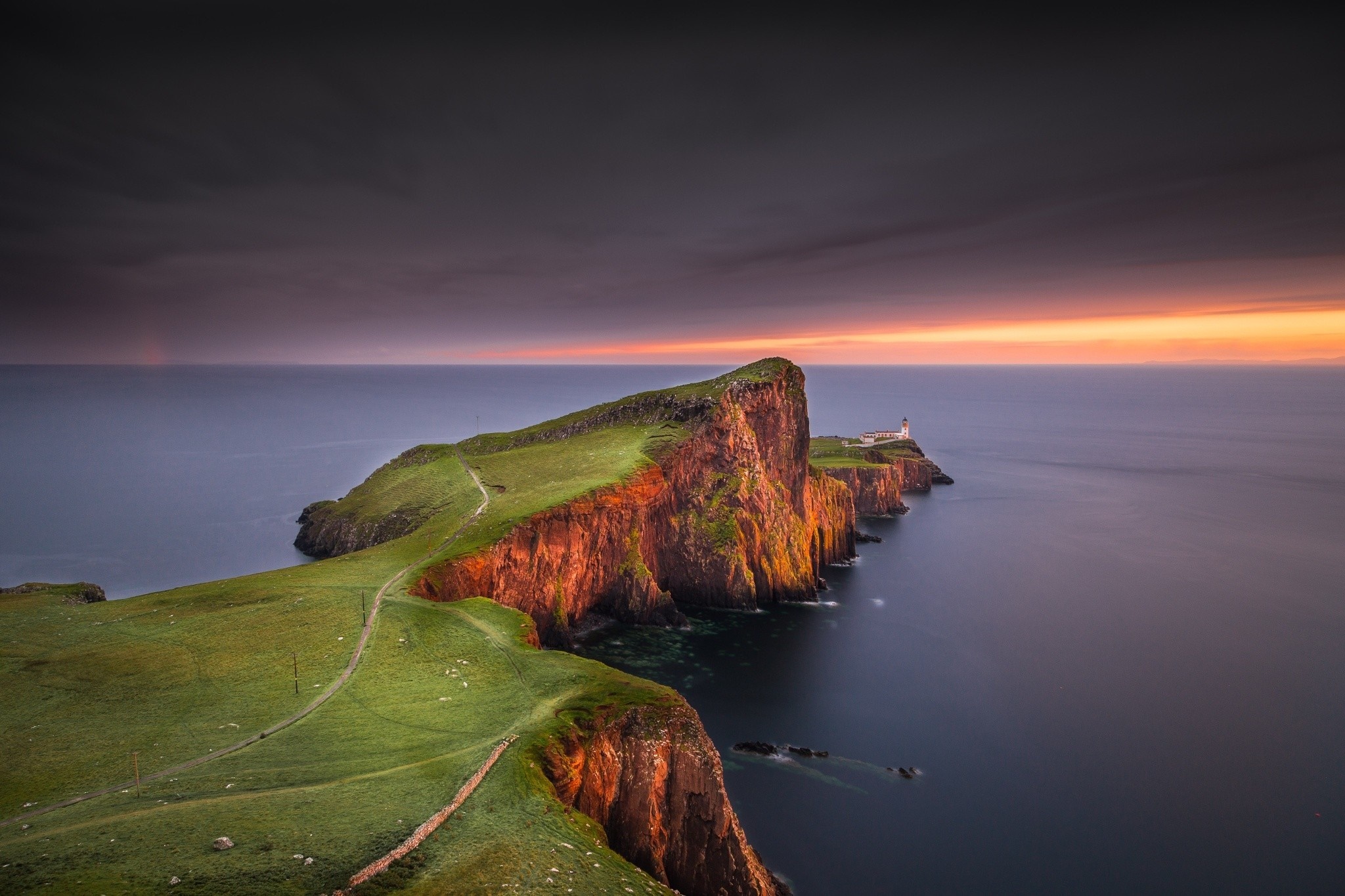 Neist Point Lighthouse on a cliff at sunset HD Wallpaper
