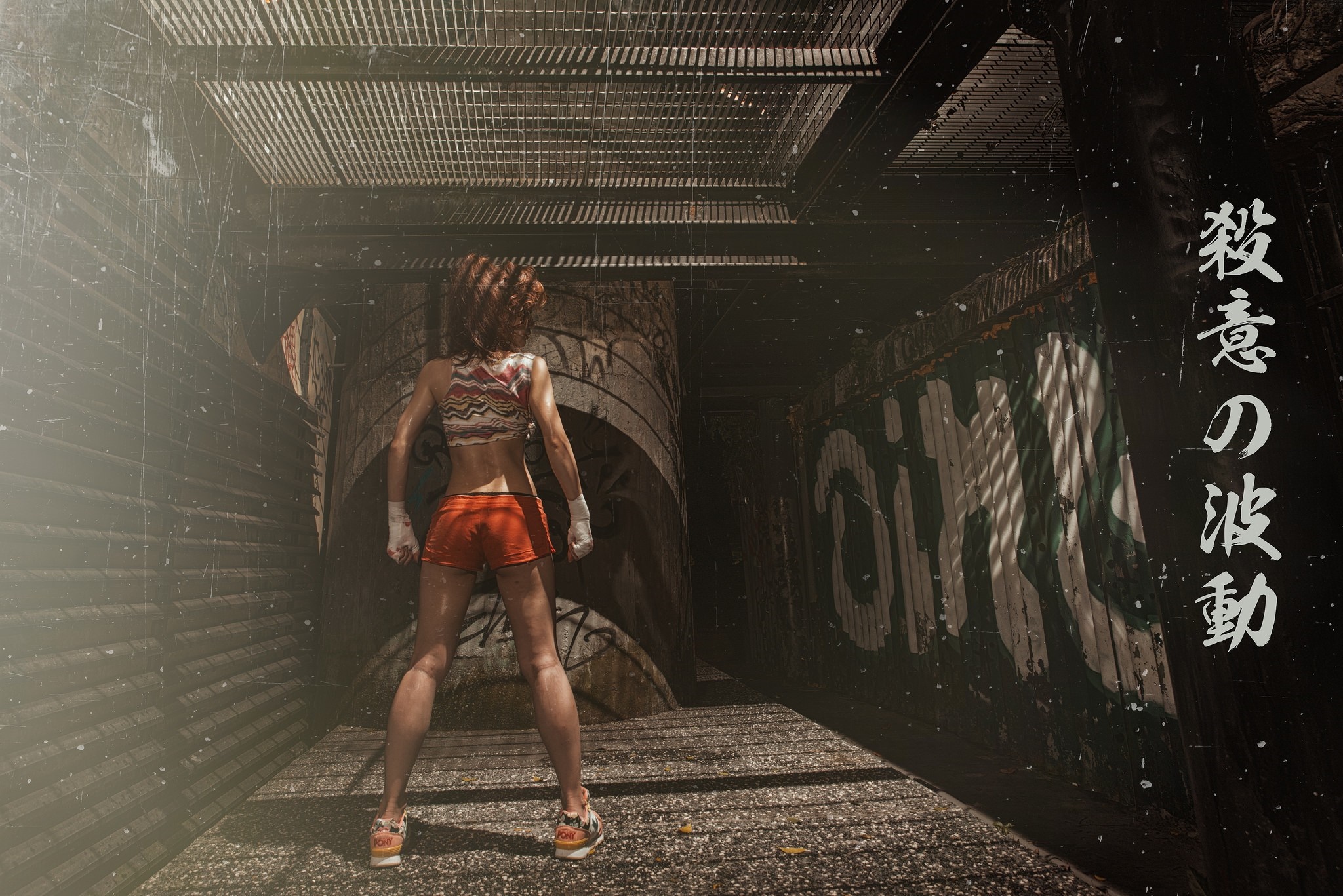 Woman in orange shorts and patterned top in alley HD Wallpaper