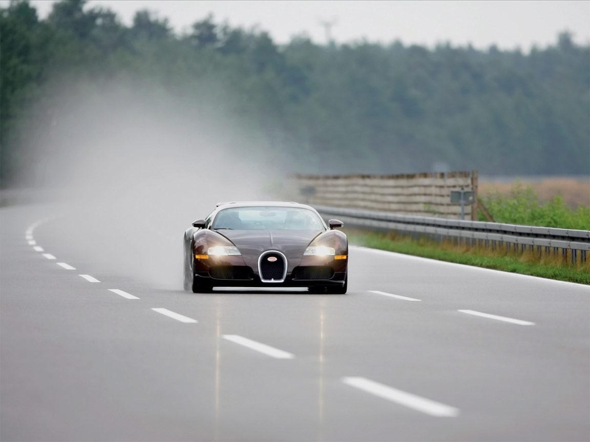 Bugatti Veyron driving through mist on a wet road HD Wallpaper