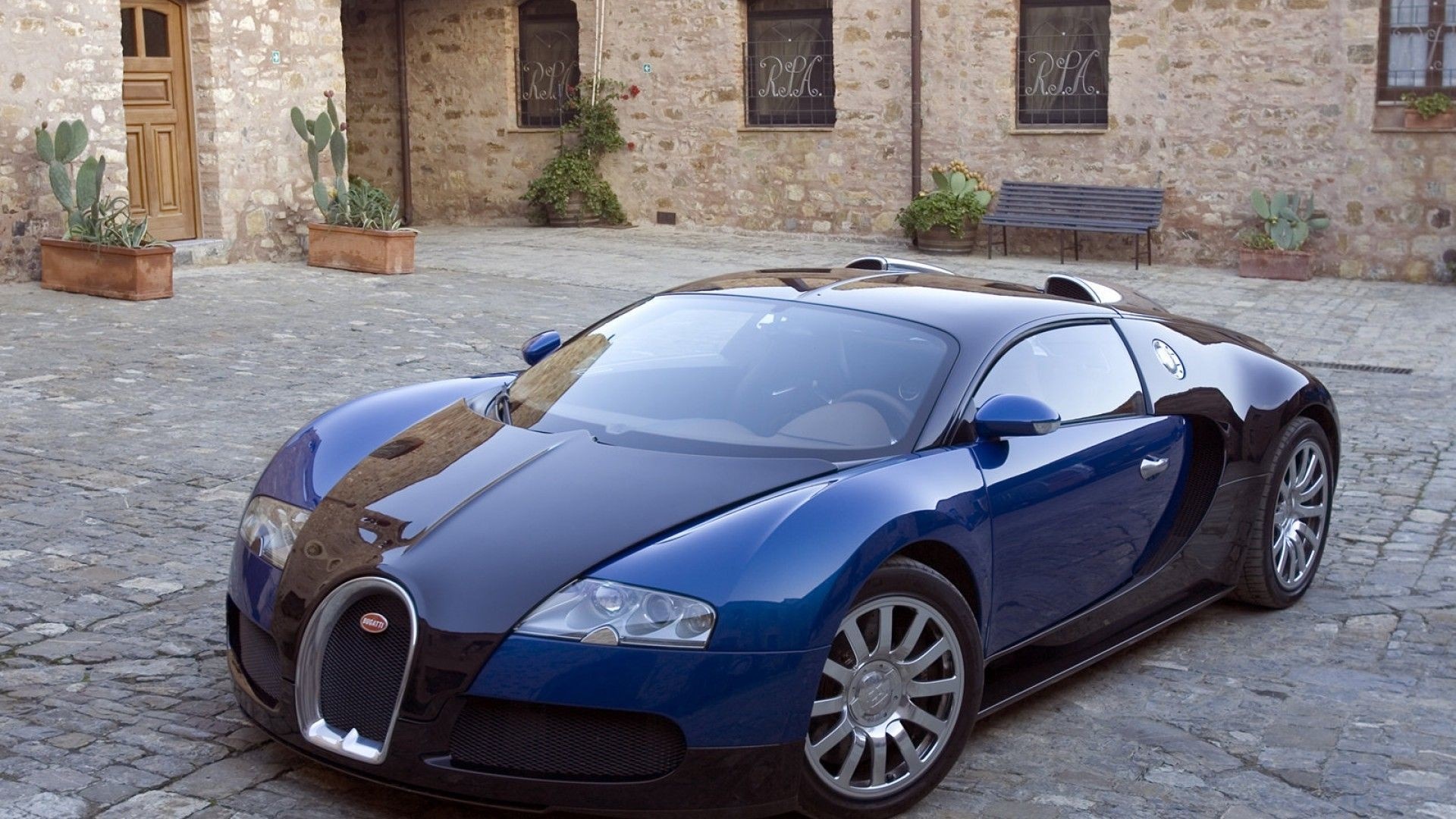 Bugatti Veyron sports car on a coastal road HD Wallpaper