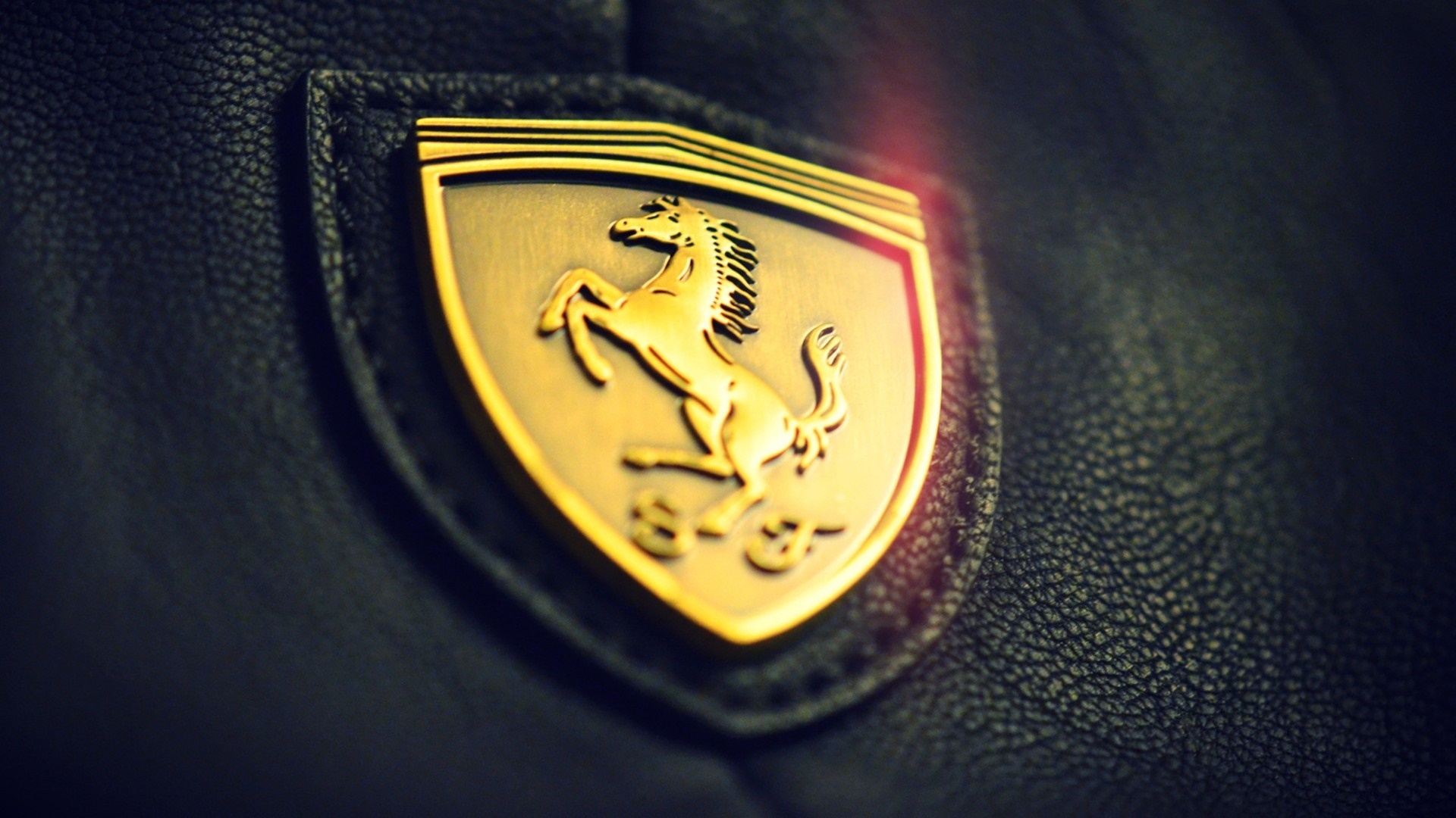 Ferrari logo on black leather HD Wallpaper