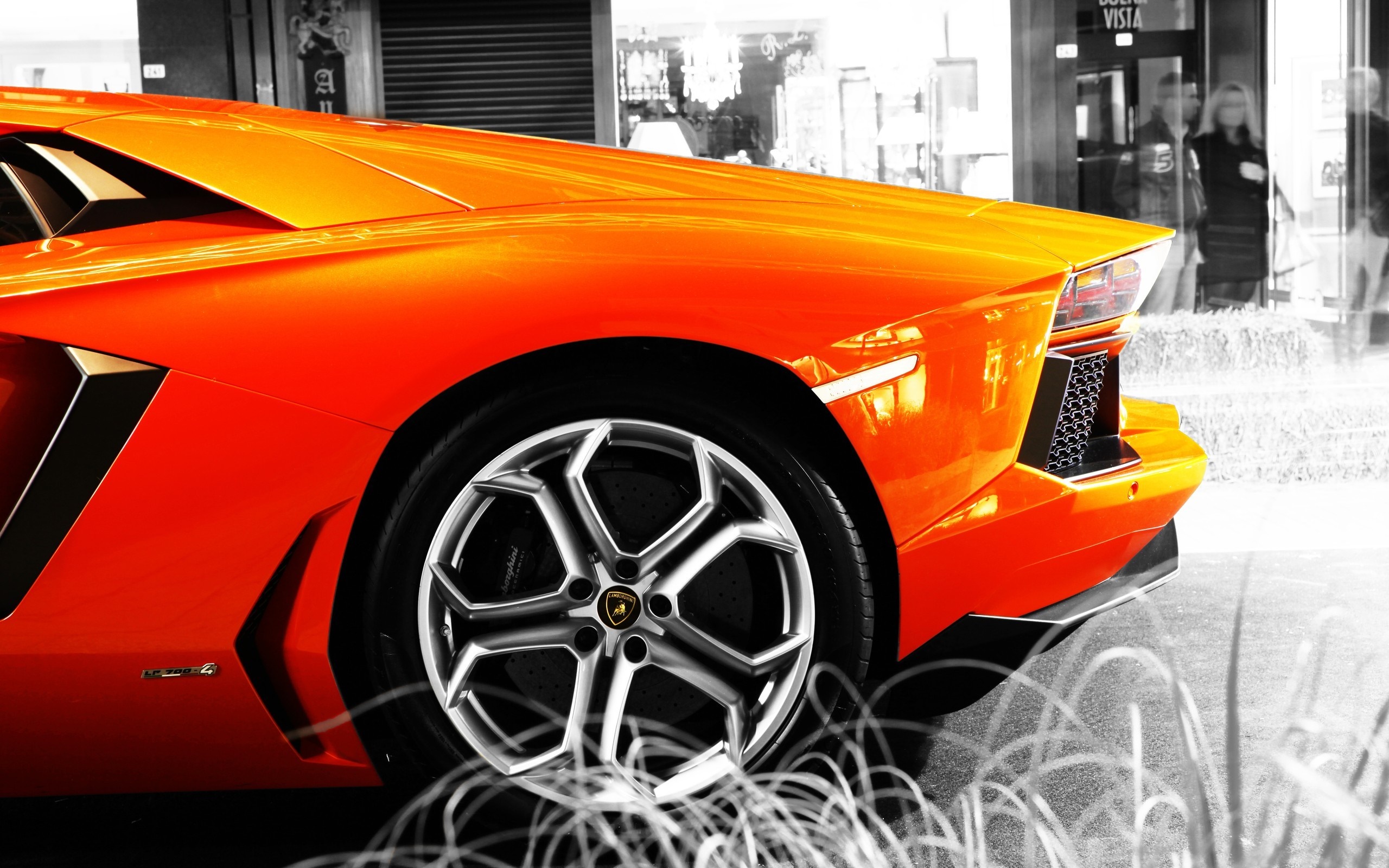 Orange Lamborghini Aventador parked outside a store HD Wallpaper