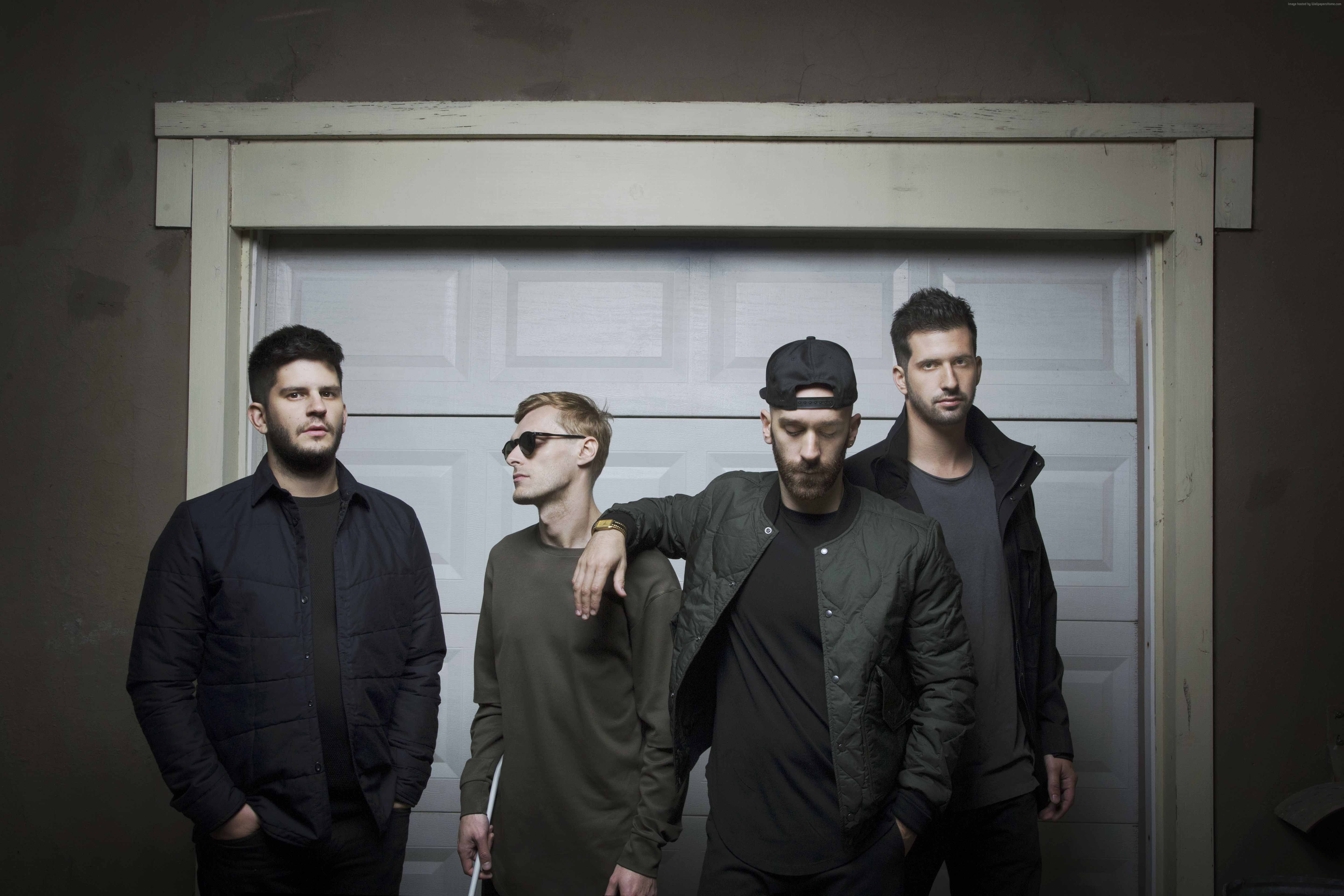 X Ambassadors band members in front of garage door HD Wallpaper