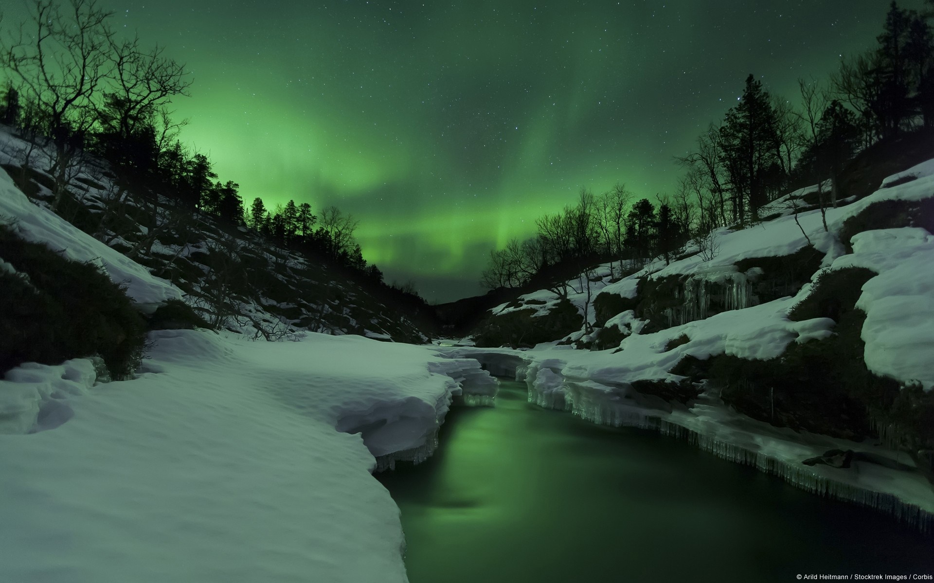 Aurora Borealis over a snowy river landscape HD Wallpaper