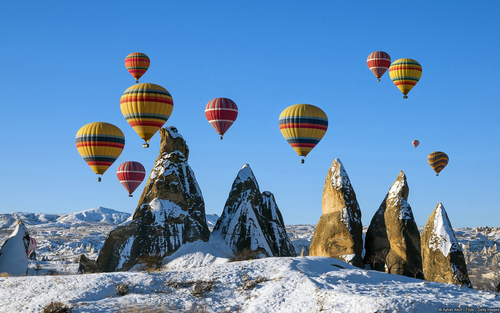 Hot air balloons over snowy mountains HD Wallpaper
