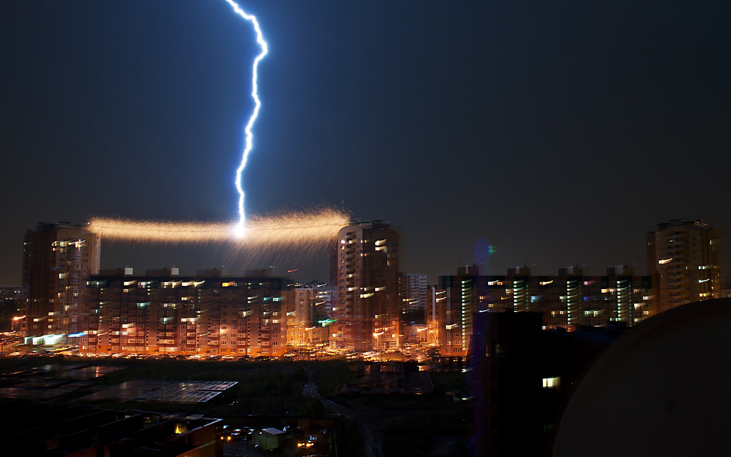 Lightning strikes a city skyline at night HD Wallpaper