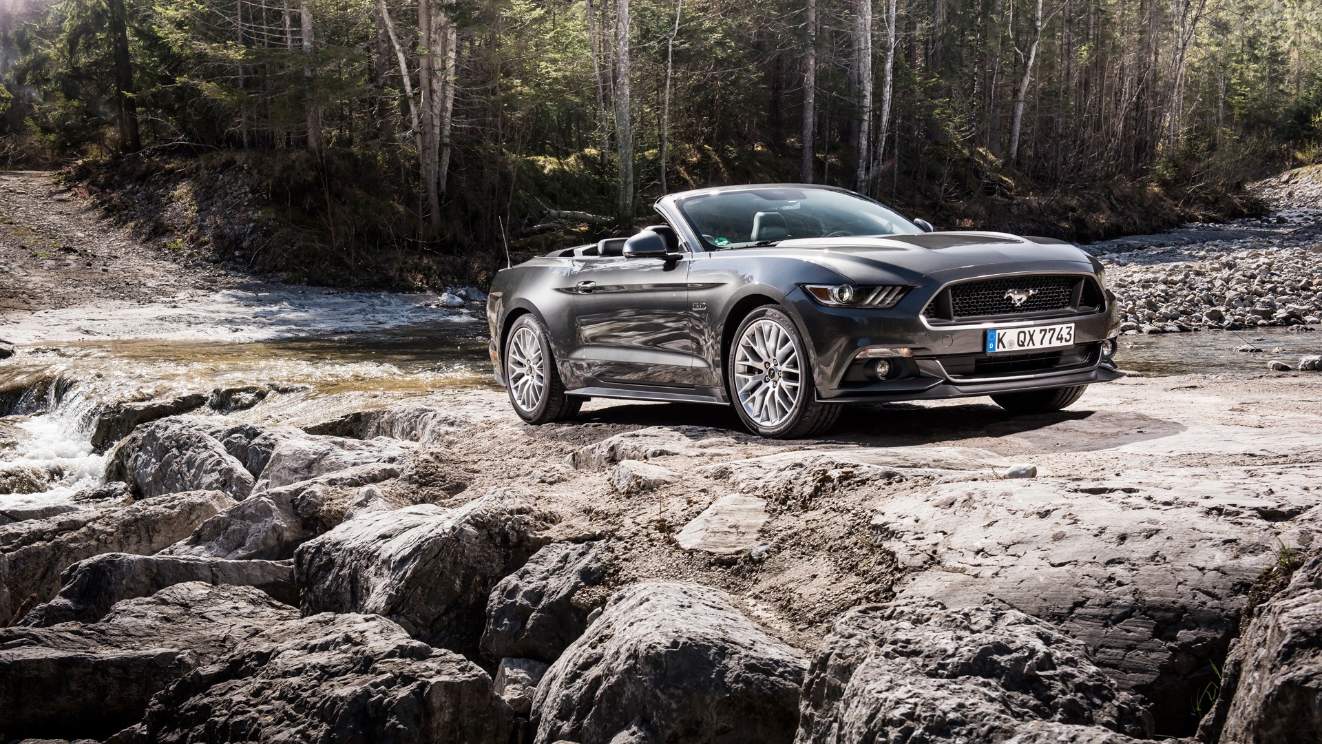 Ford Mustang Convertible on rocky riverbank HD Wallpaper