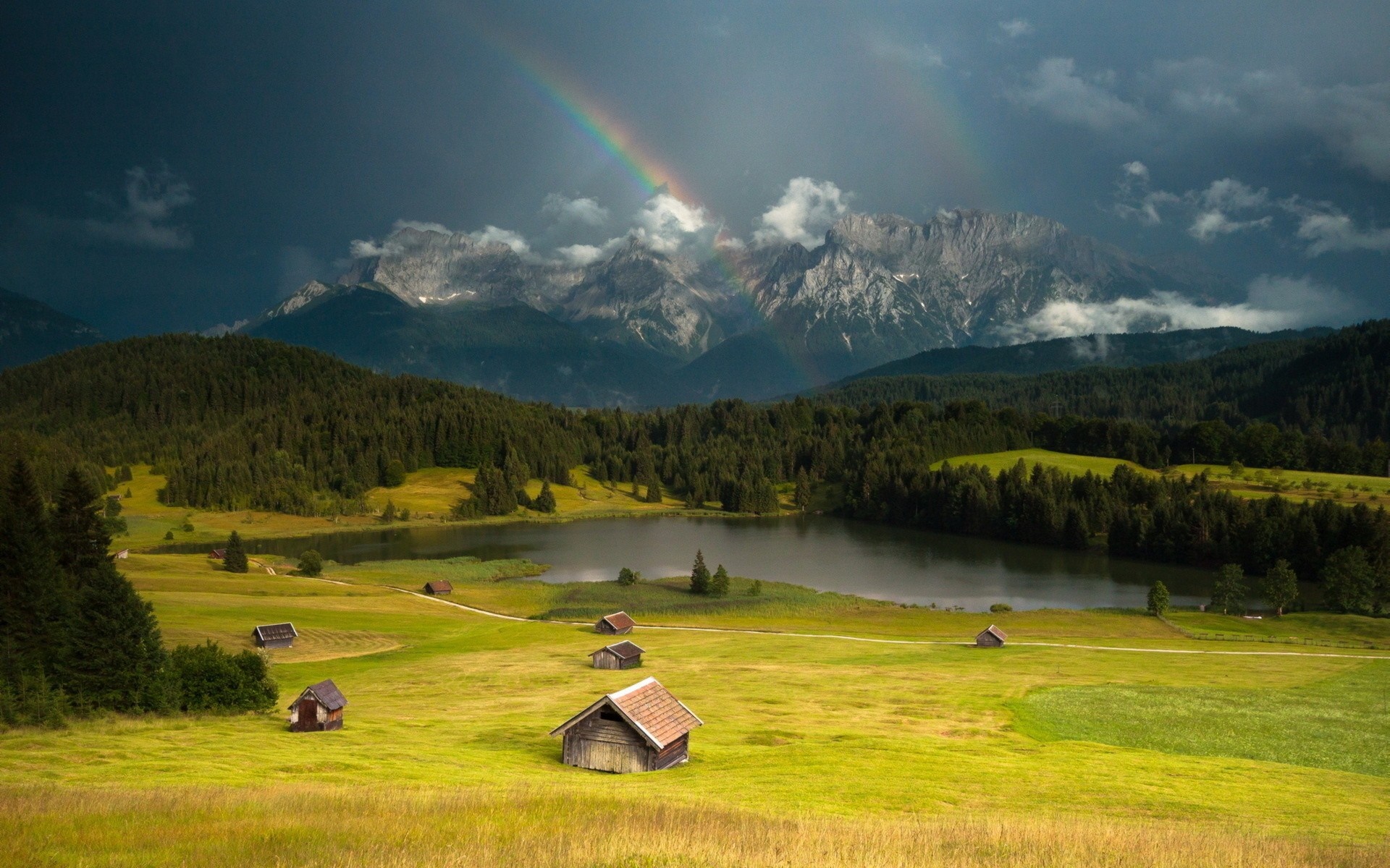 Double rainbow over mountains and lake with cabins HD Wallpaper