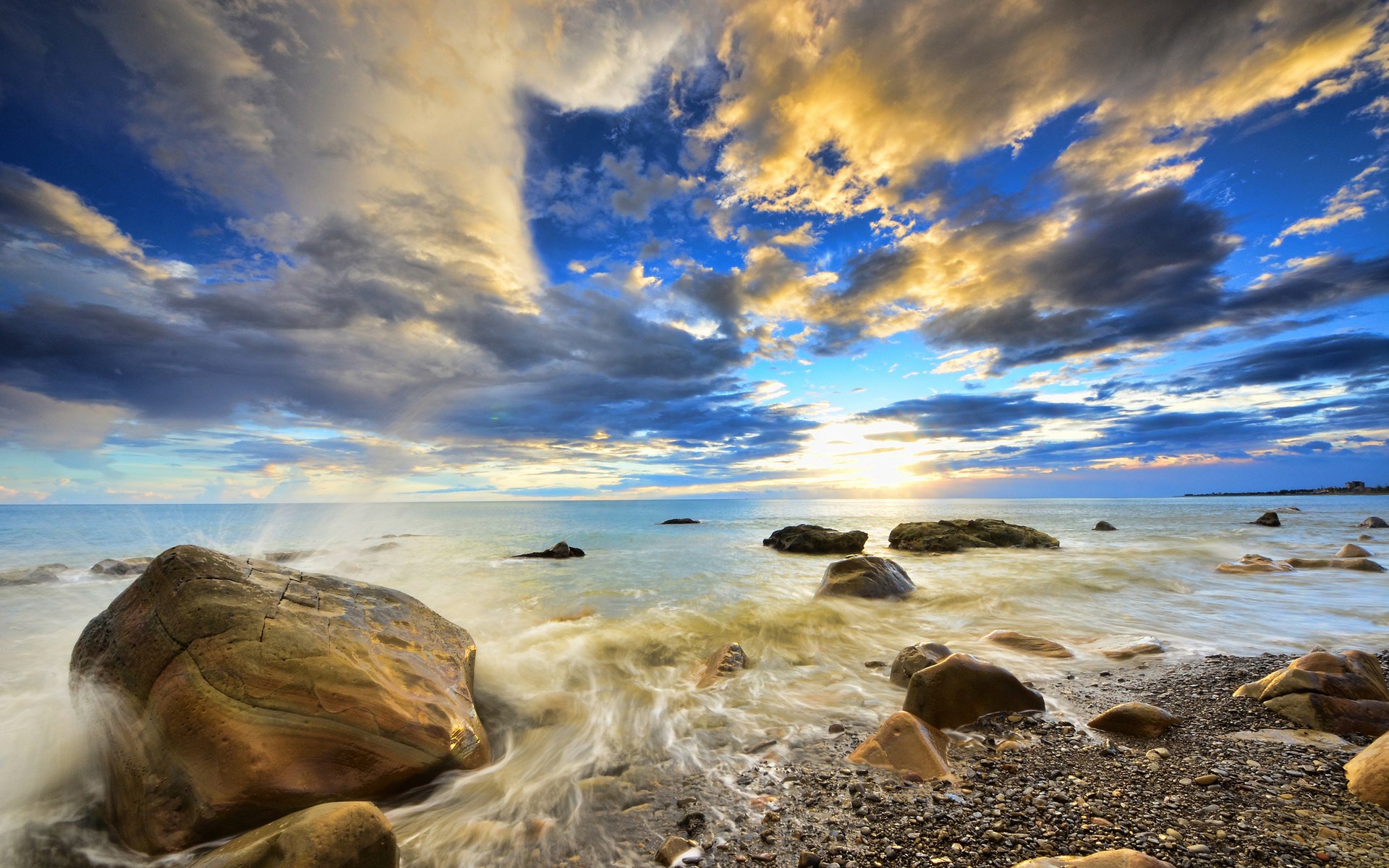 Waves crashing on rocky shore at sunset HD Wallpaper