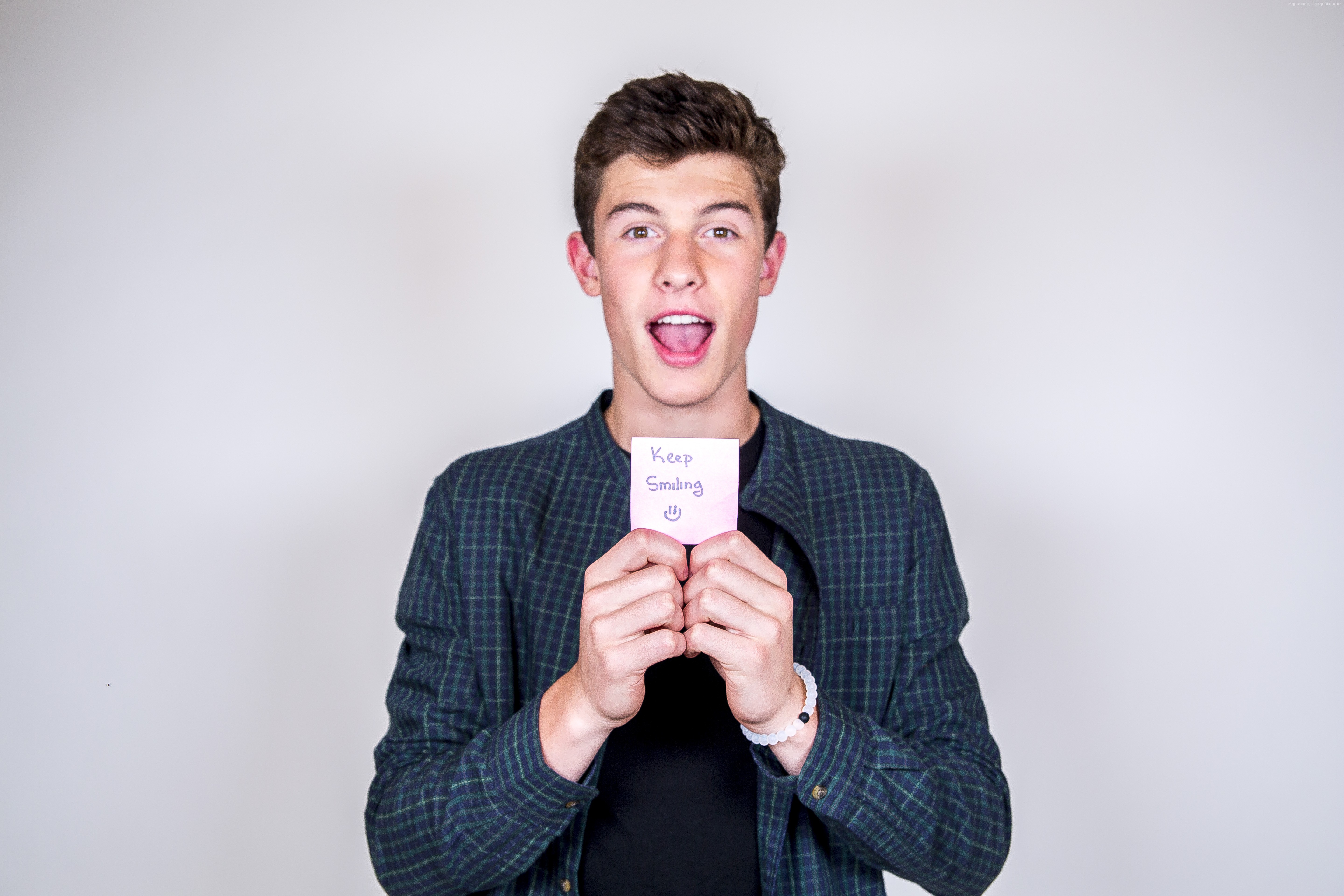Shawn Mendes holding a 'Keep Smiling' note HD Wallpaper
