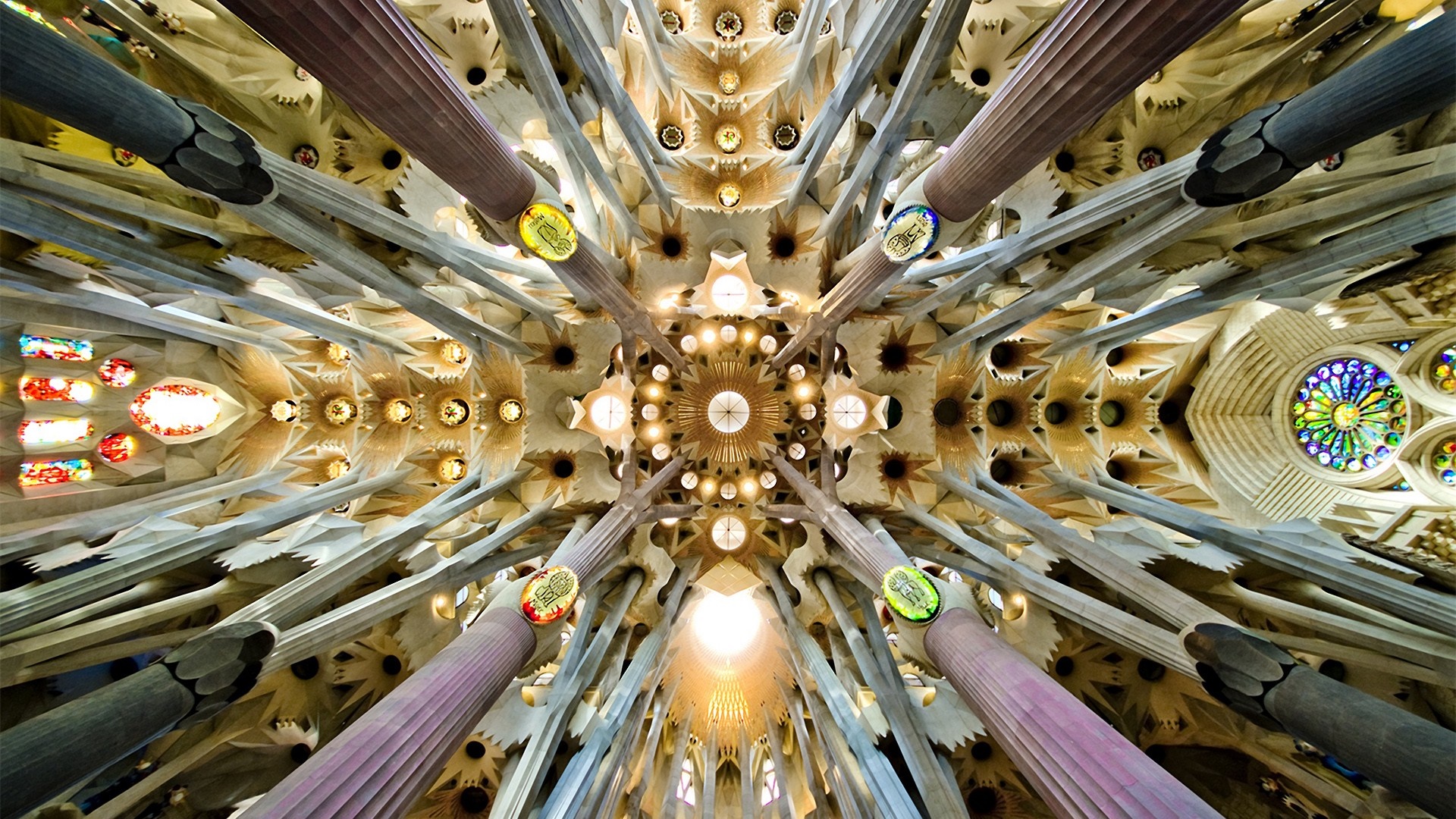 Interior view of Sagrada Familia with columns and stained glass windows HD Wallpaper