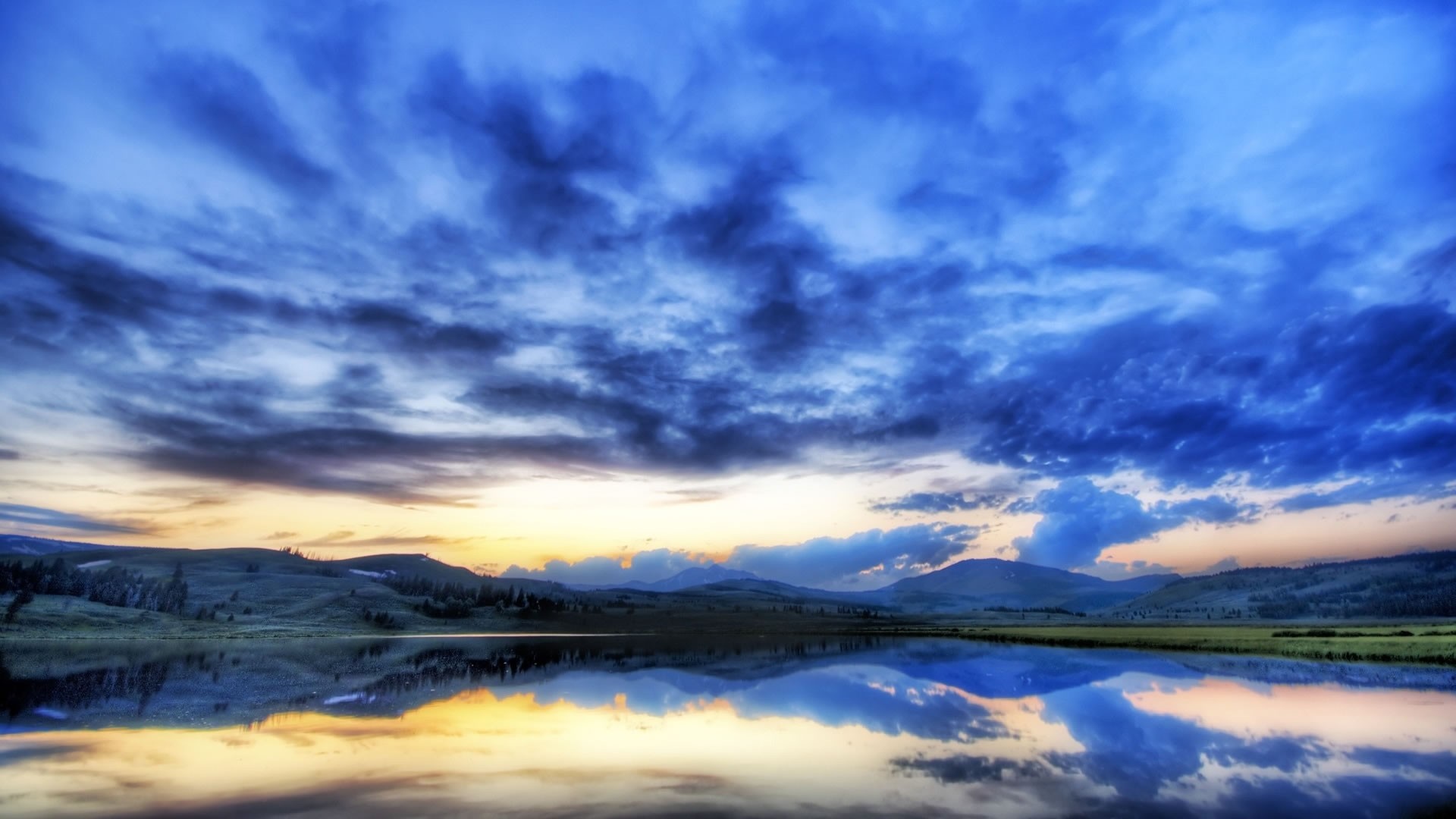 Lake reflection at sunset with dramatic clouds HD Wallpaper