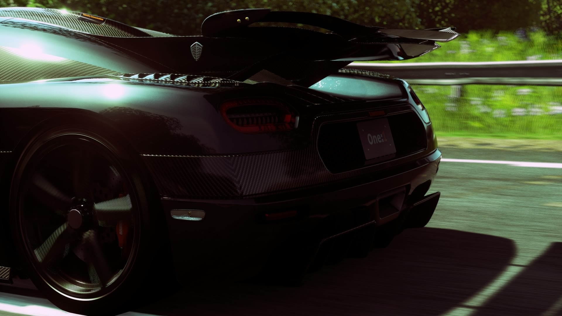 Black Koenigsegg One:1 supercar on a road HD Wallpaper