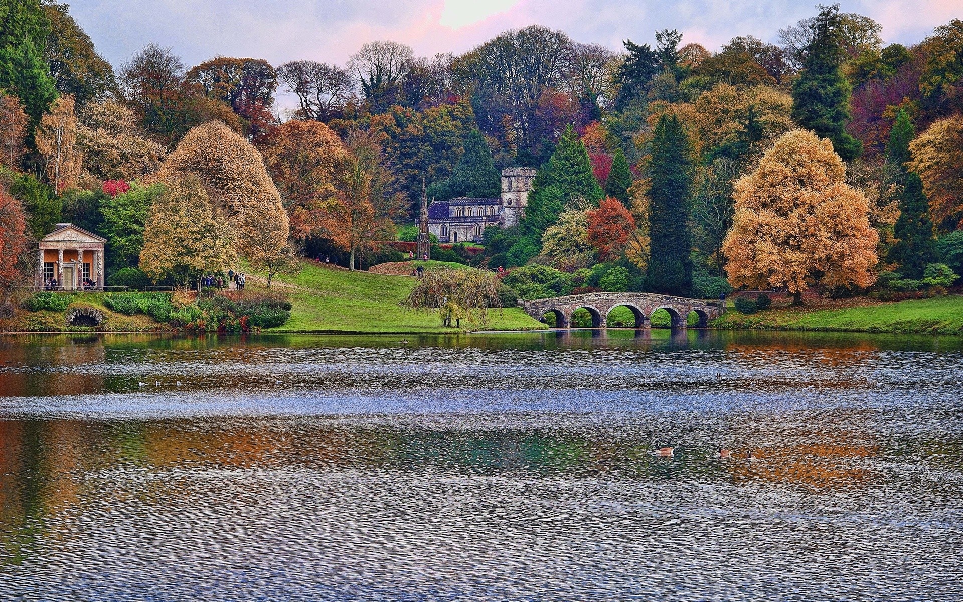 Autumn landscape with a lake, bridge, and classical buildings HD Wallpaper