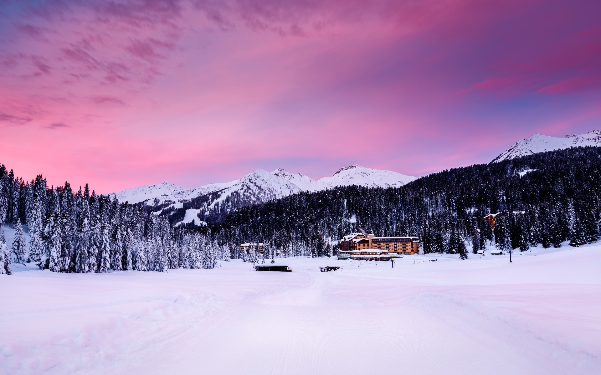 Snowy mountain landscape with a hotel at sunset HD Wallpaper