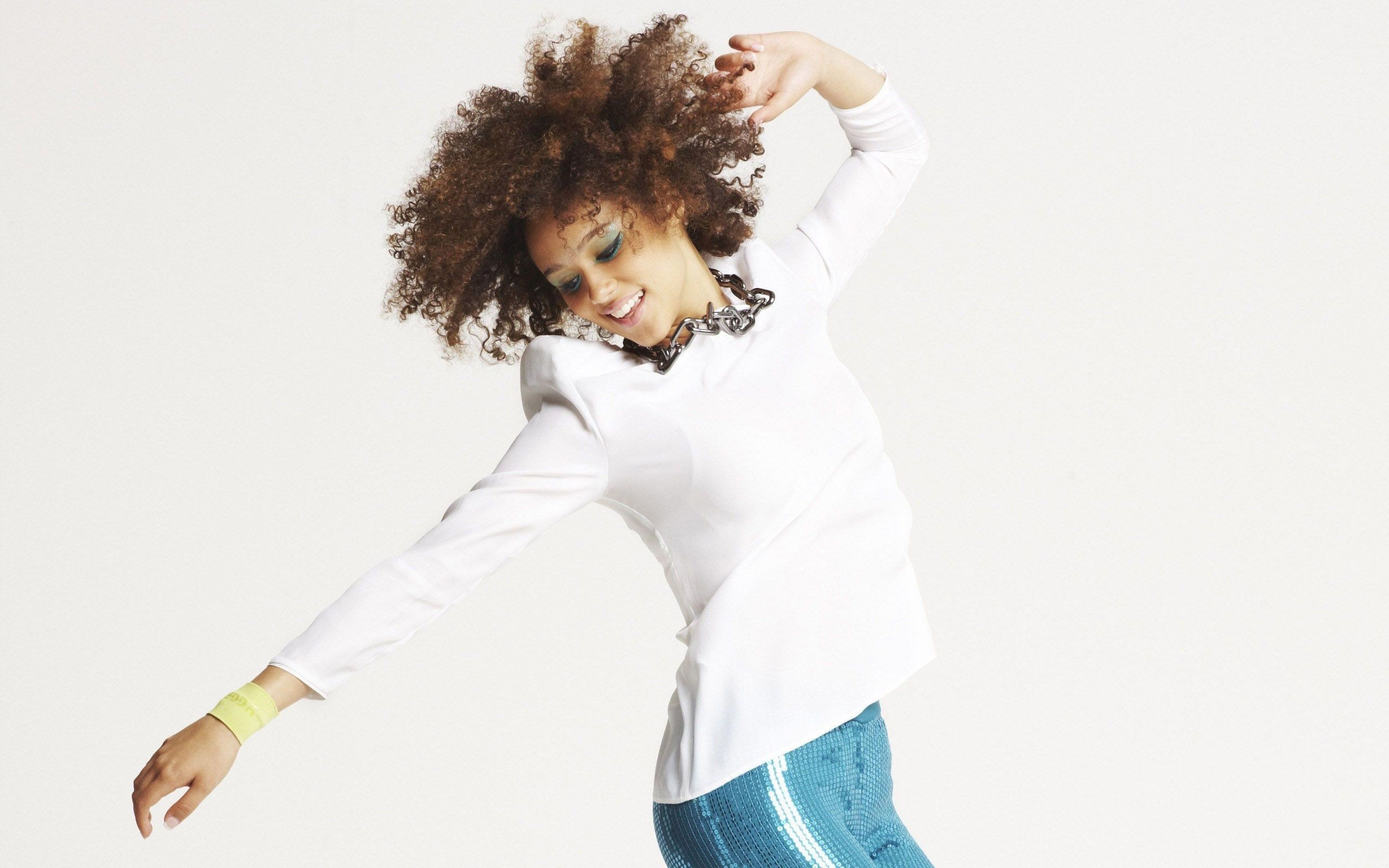 Nathalie Emmanuel dancing in white top and blue skirt HD Wallpaper
