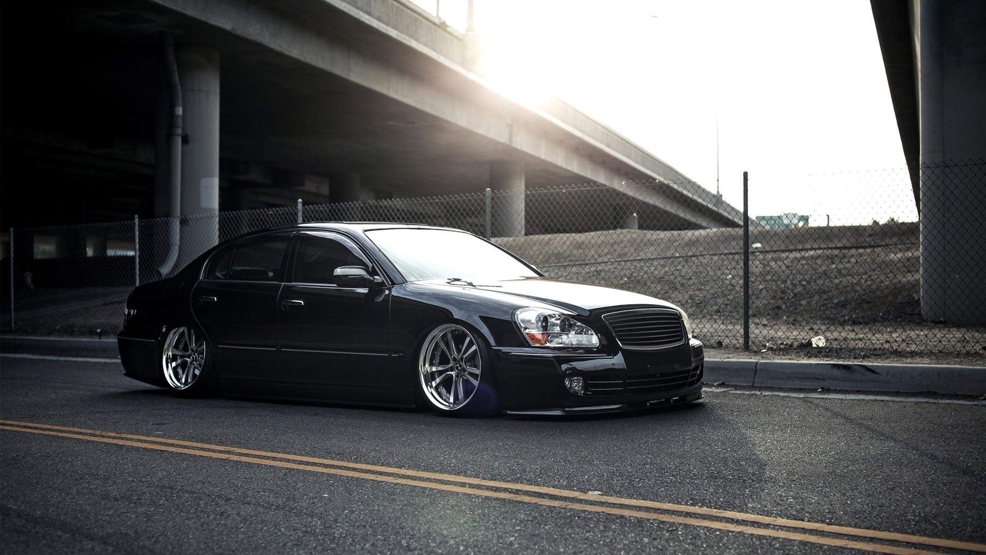 Black sedan with custom rims parked on the street HD Wallpaper