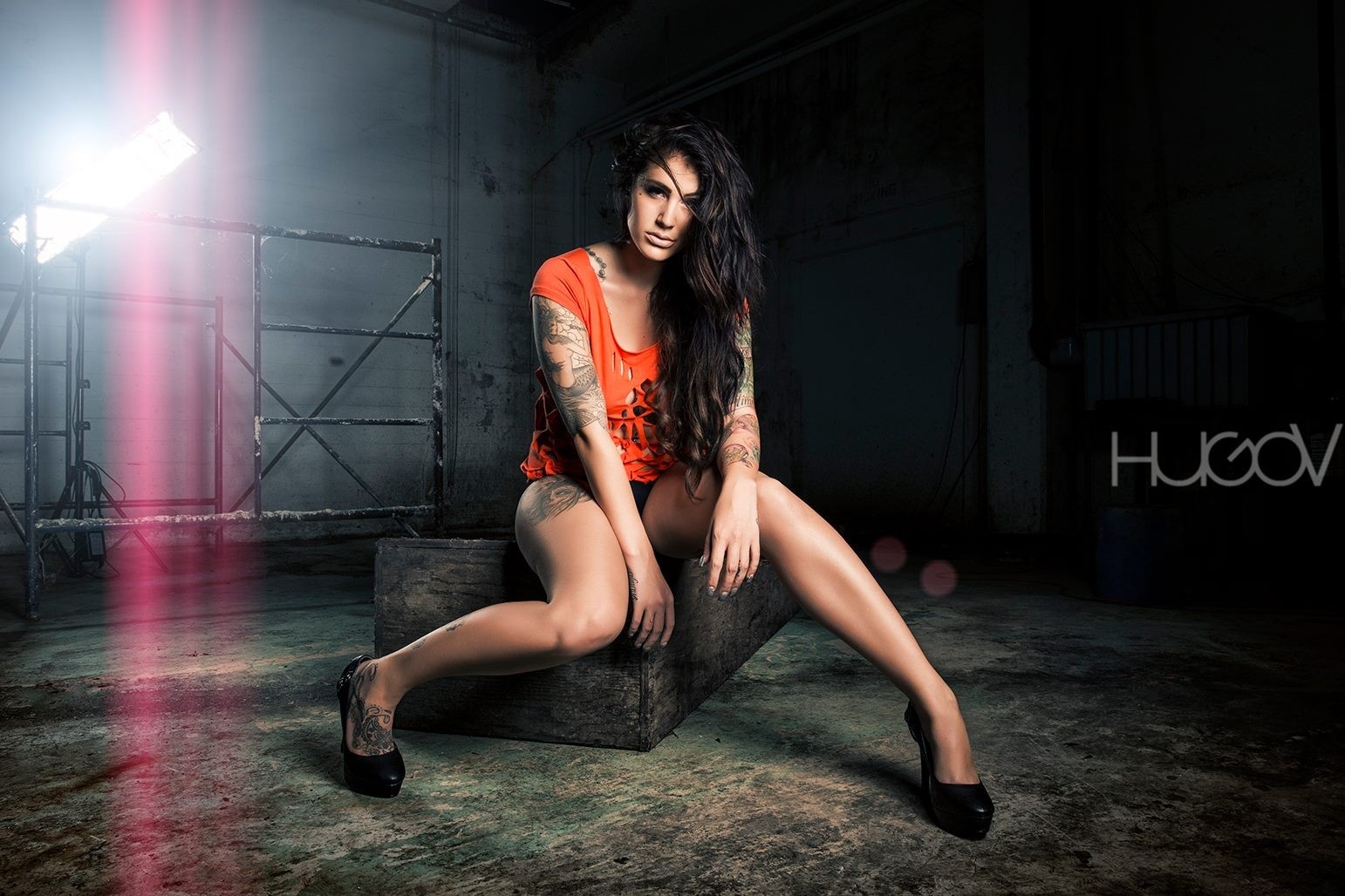 Woman with tattoos sitting in a dark room HD Wallpaper