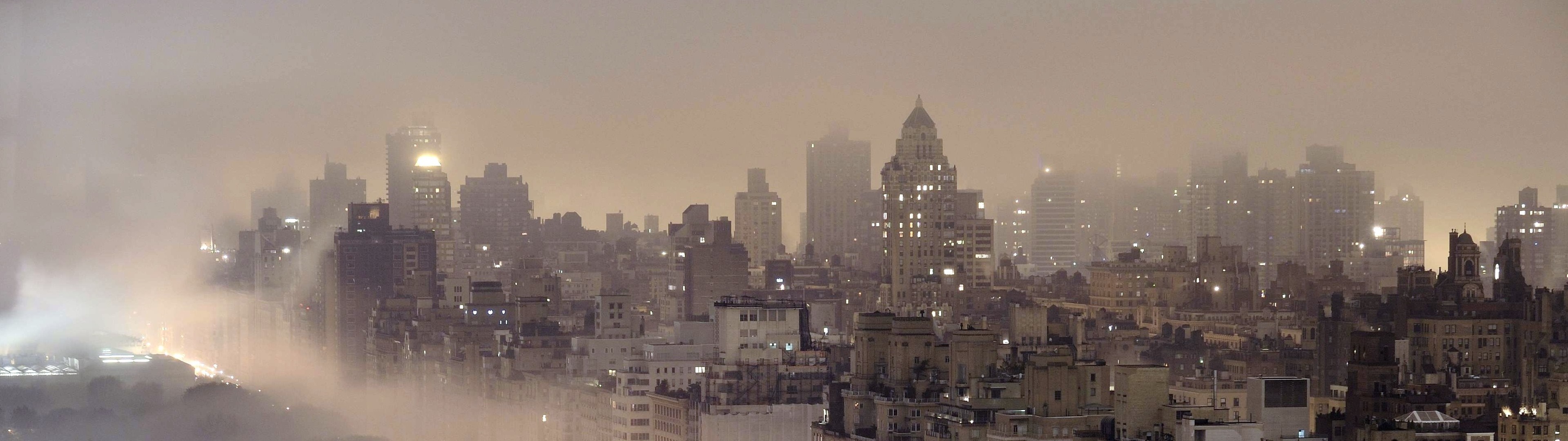Panoramic cityscape of a foggy metropolis at night HD Wallpaper