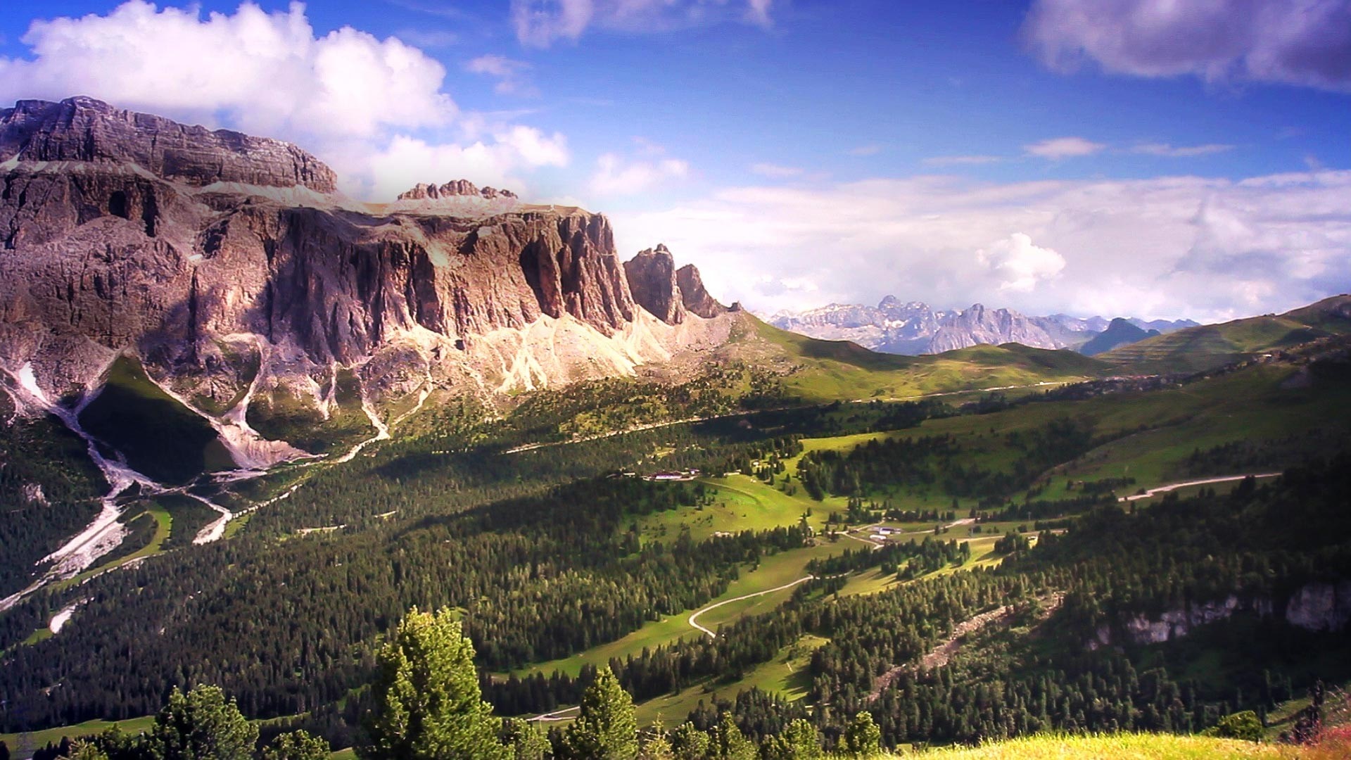 Mountain range with valley and forest in the Alps HD Wallpaper