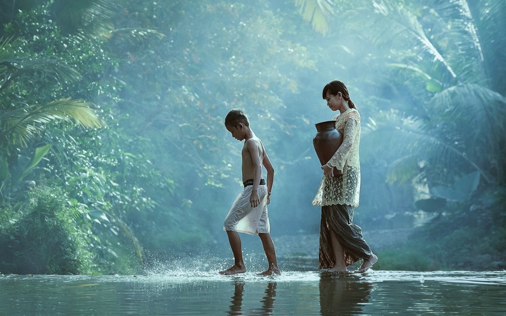 Children walking through water in a tropical forest HD Wallpaper
