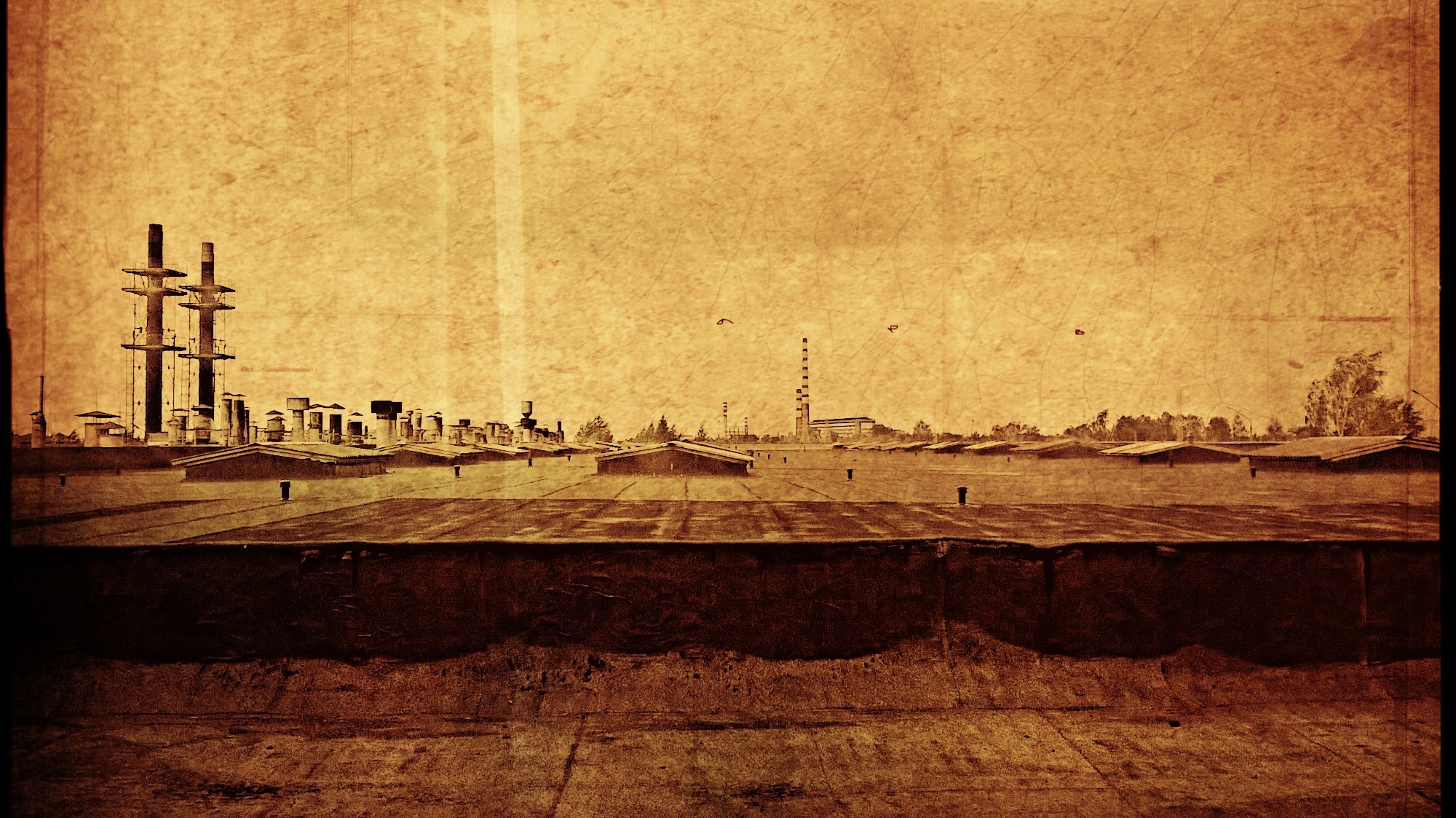 Sepia-toned industrial complex with rooftops and smokestacks HD Wallpaper