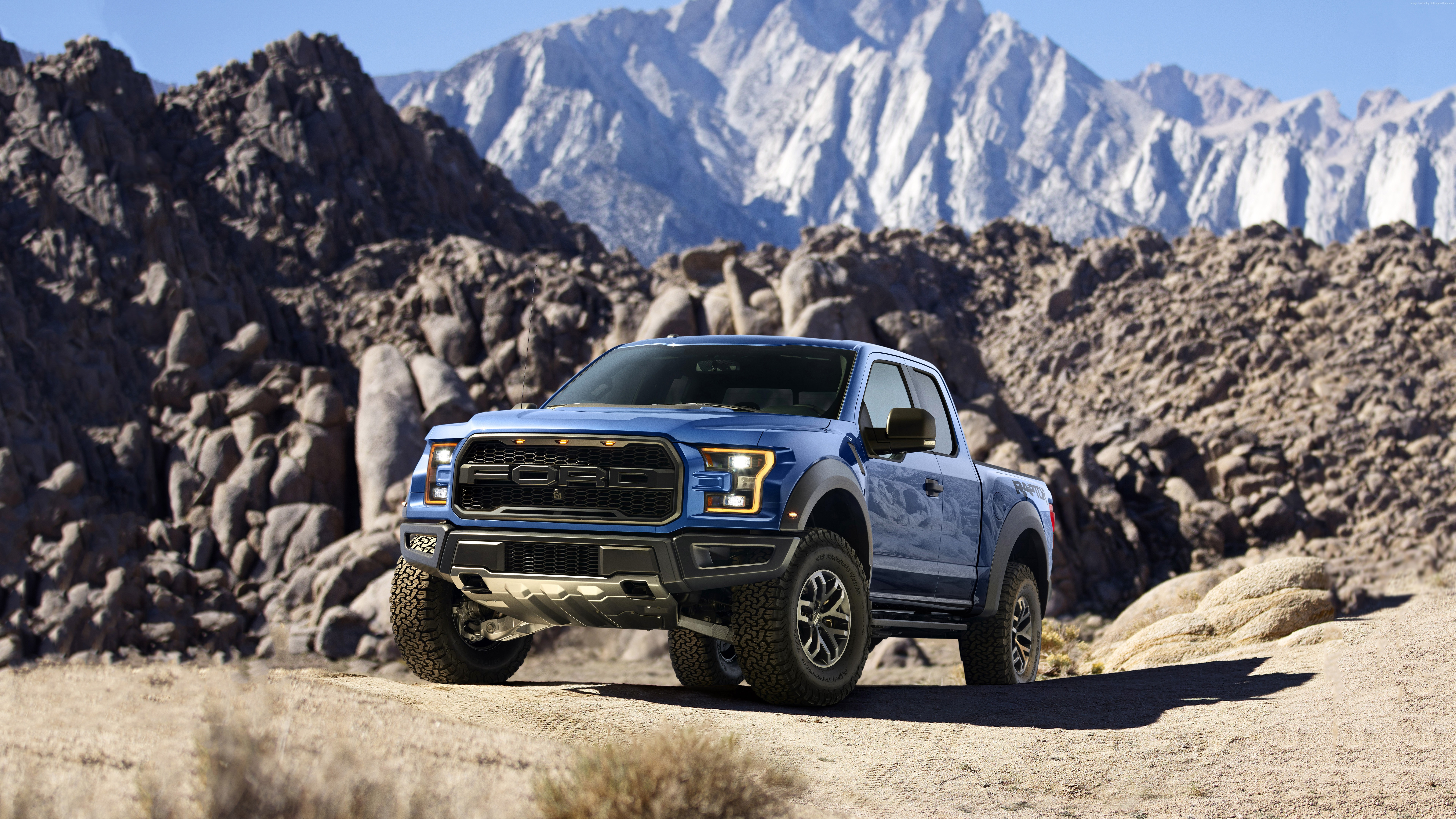 Blue Ford F-150 Raptor in a rocky desert landscape HD Wallpaper