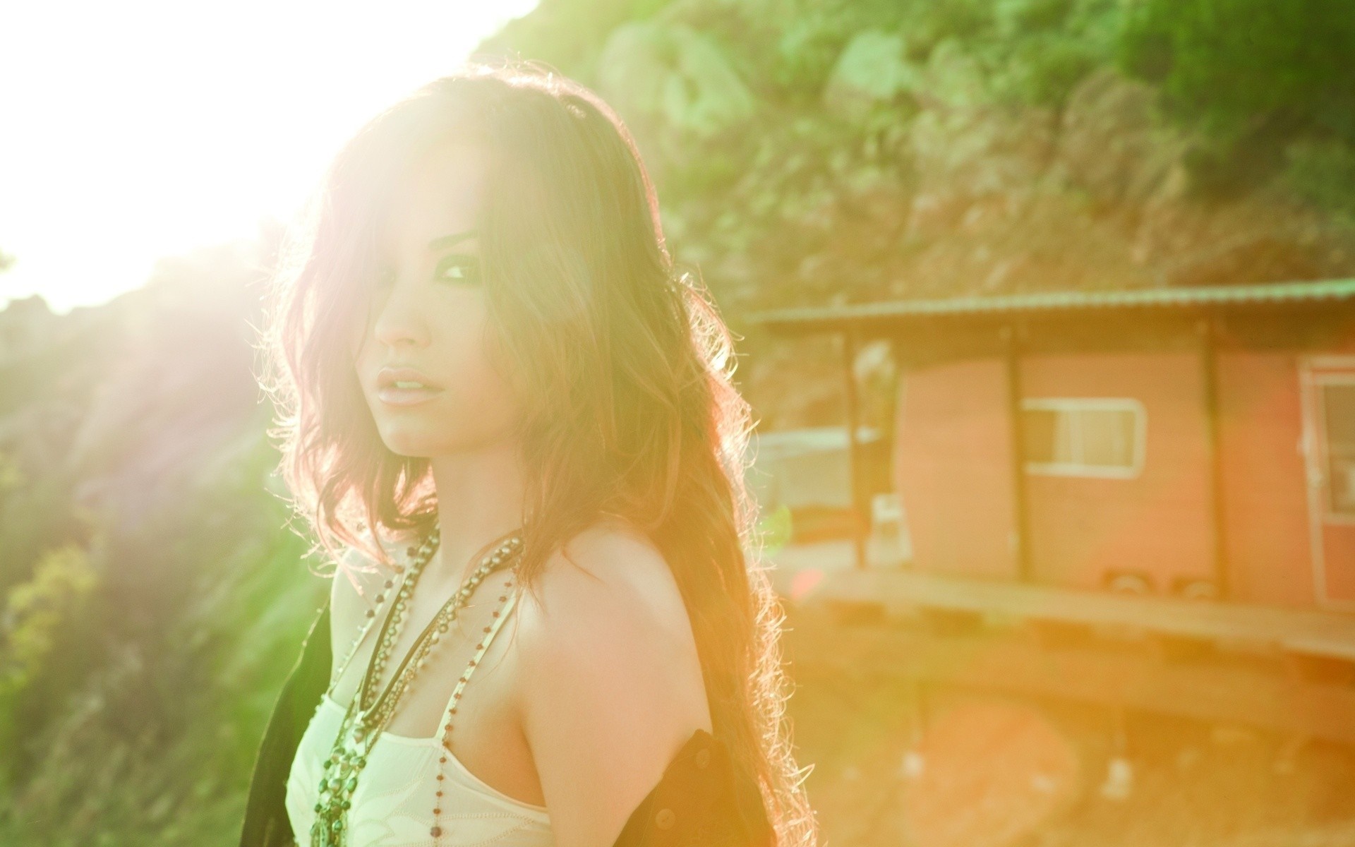 Demi Lovato in sunlight near a building HD Wallpaper