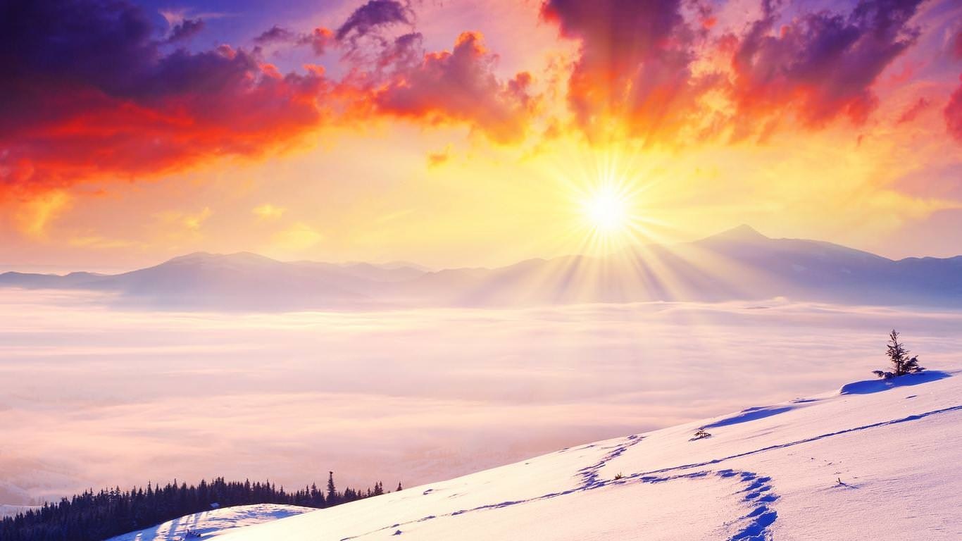 Sunrise over snowy mountains with fog and colorful clouds HD Wallpaper